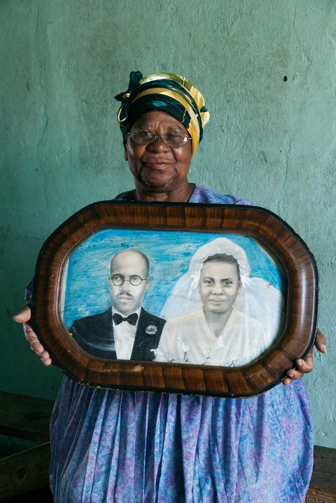 Angeline Mboyi is a retired teacher. She holds the framed, hand-coloured wedding portrait of her parents.
(Batho Location, Mangaung, Free State).