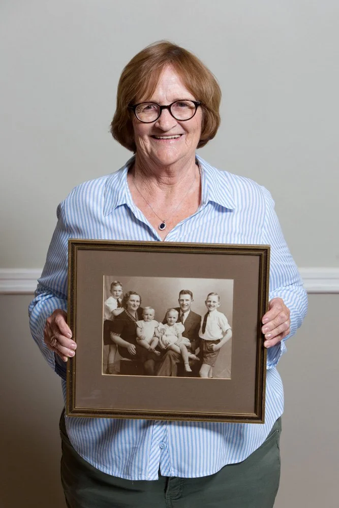 Retired typist Mrs. Barbara Greyling is a keen genealogist and painter with a home full of old photographs and artworks. She holds a framed, analog black-and-white portrait of her parents and siblings: the Prior family. In 1948, Errol and Sophie Prio