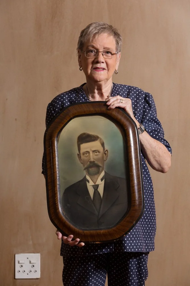 Engela Roets holds a framed, hand-coloured photograph (ca. 1920) of her grandfather, Christoffel Vermeulen, who was a diamond digger. (Dan Pienaar/Bloemfontein, Free State).