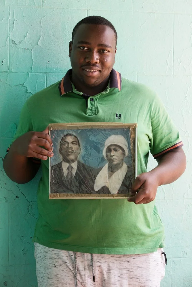 Samuel Magengenene, who is named after the gentleman in the portrait, holds a plastic-wrapped, hand-coloured black-and-white photograph of his great-grandparents, Samuel Tlae Nkone and Rosta Nobelungu. Grandfather Samuel was a prison warden, Gran Ros
