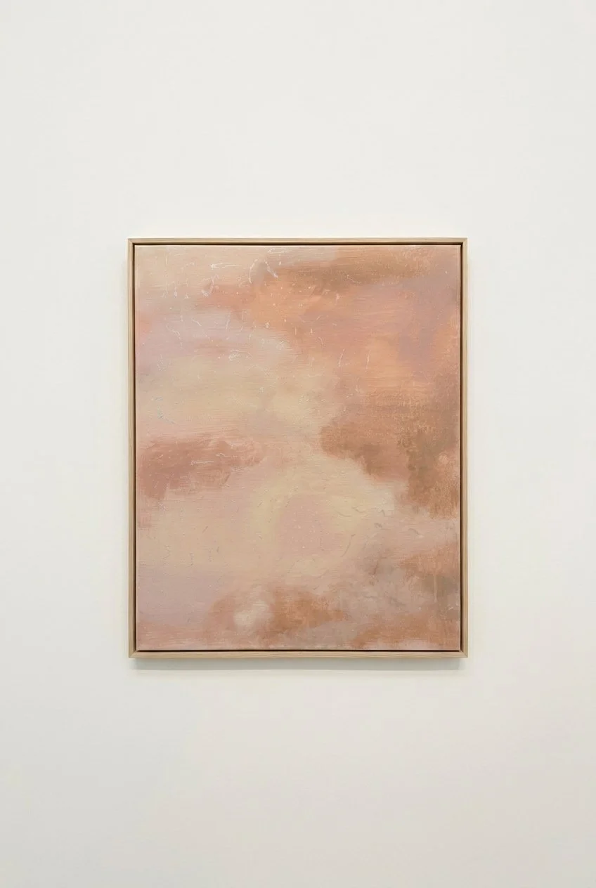 Abstract painting named "droplets on her skin" with atmospheric soft pink, beige, and brown tones and iridescent pearl markings only visible in natural light, hang on a white wall.