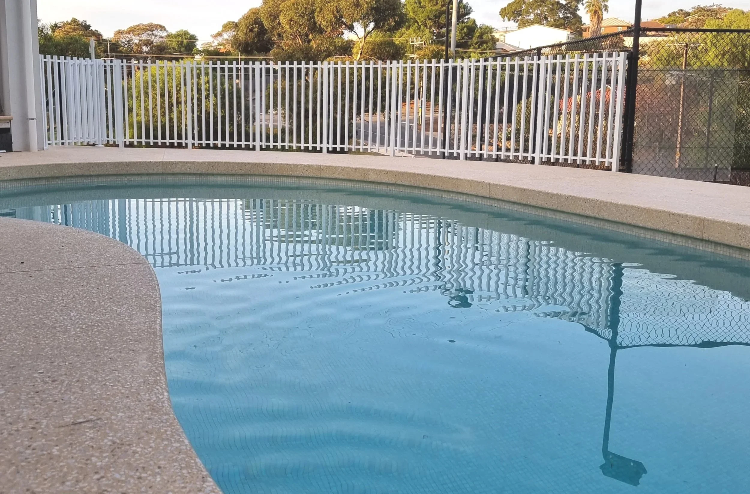 Architectural floor plan showing a rectangular swimming pool with a raised central section and surrounding dimensions