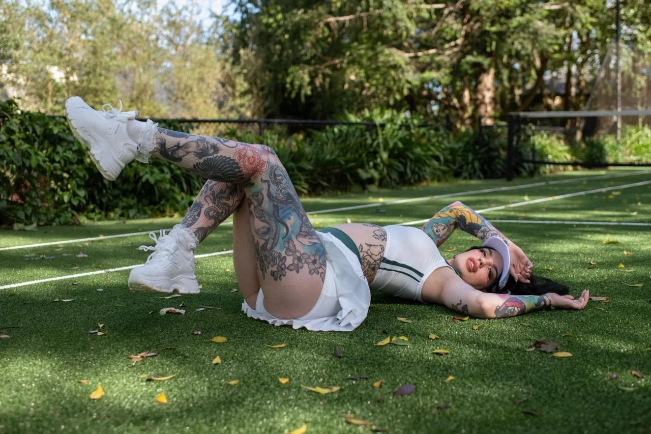 Amity Addams lying on the grass during a playful afternoon outdoors.
