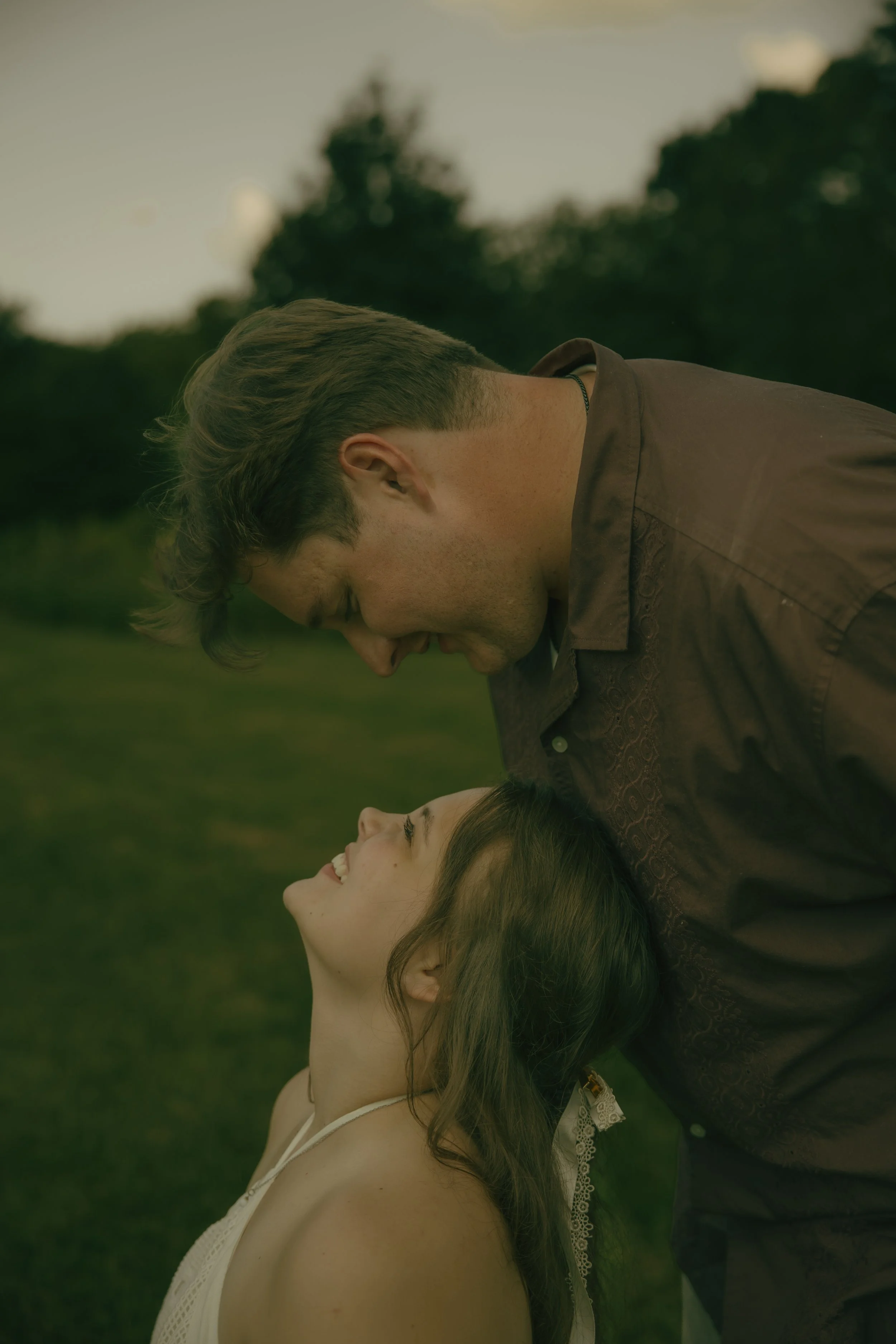 Couple laughing together during a candid outdoor couples photography session