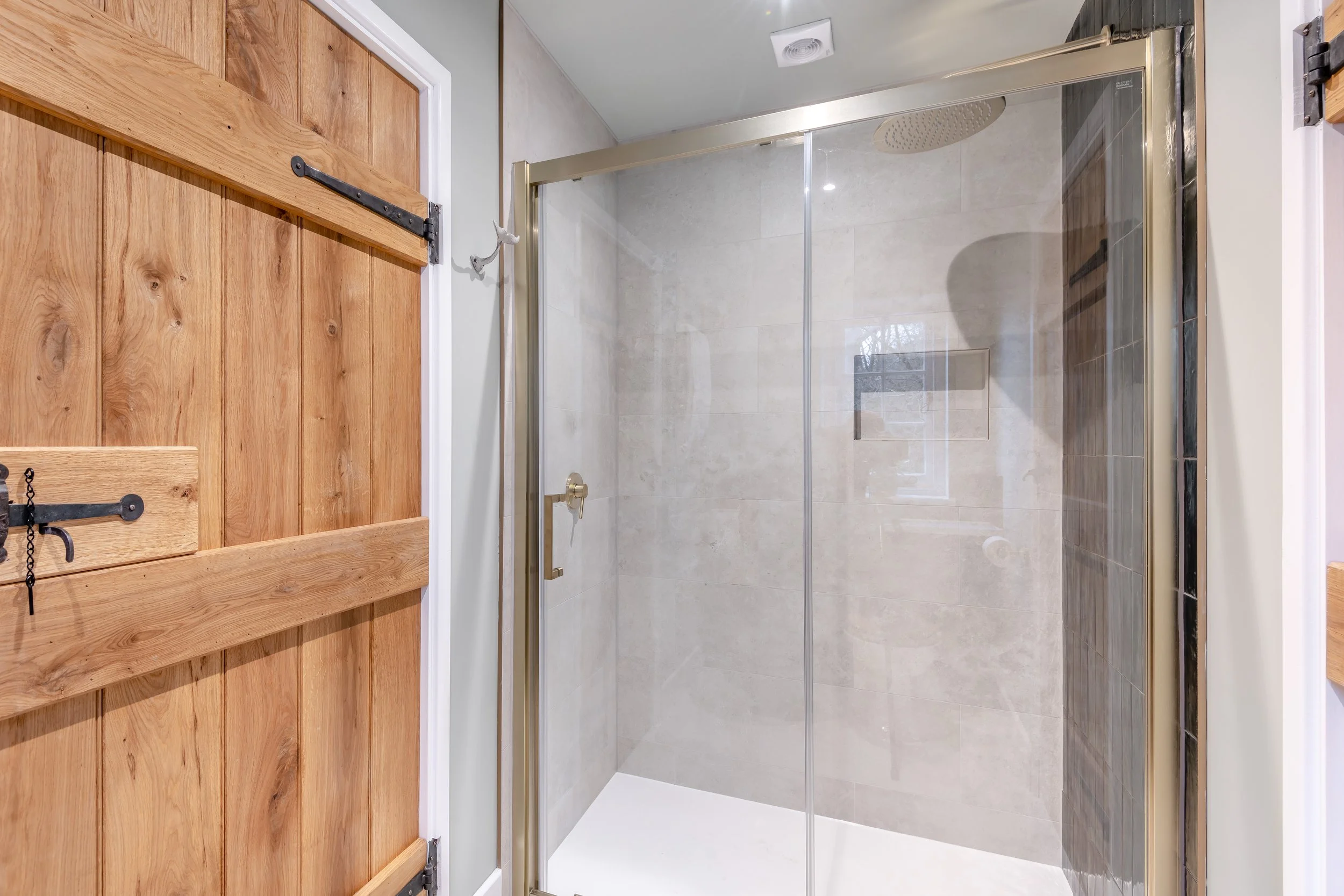 The secondary bathroom, a Jack and Jill complete with spacious shower with a waterfall head.