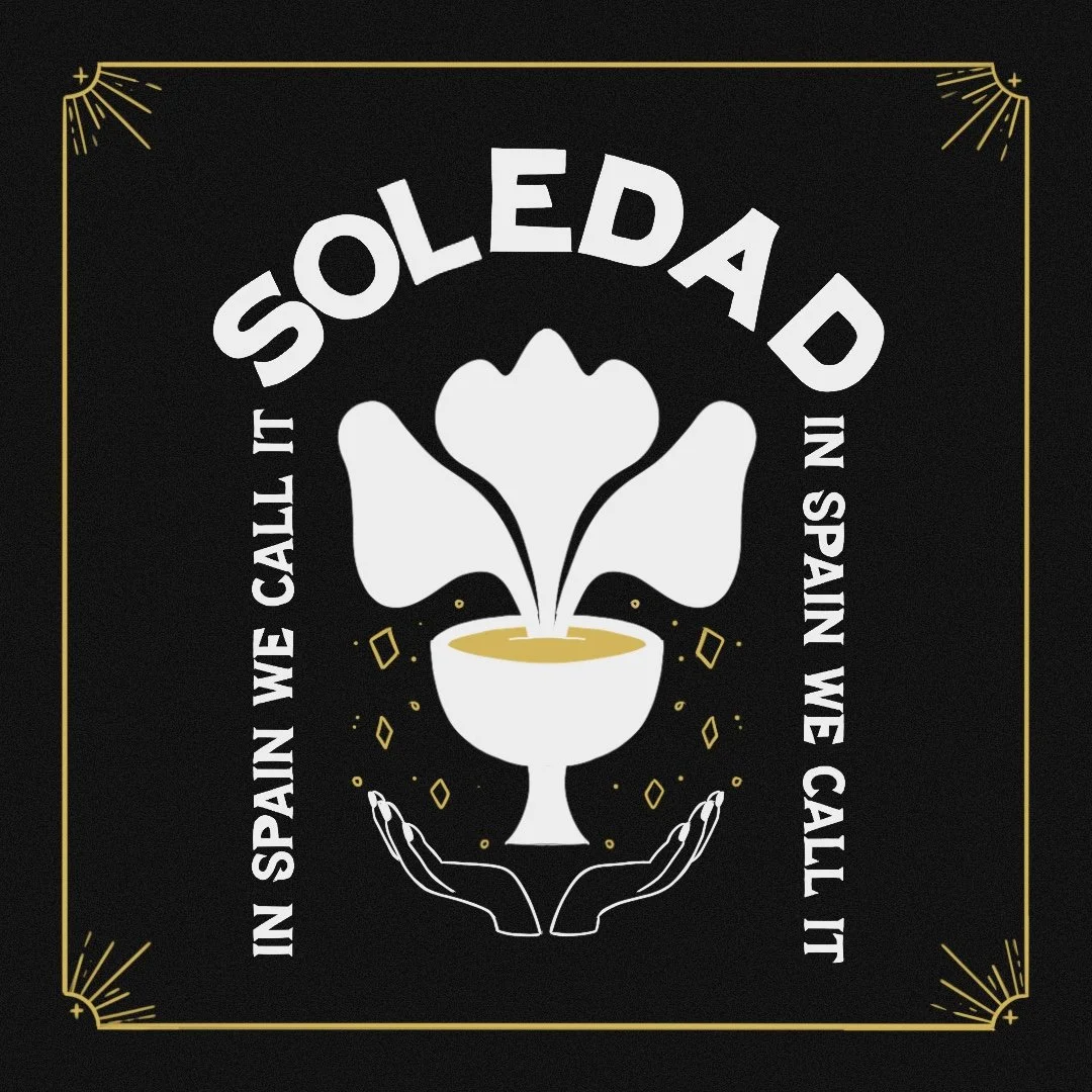 A black square graphic with gold corners, featuring a white cacao pod with three heart-shaped seeds, a steaming cup beneath, and two illustrated hands cupping the cup. Surrounding the cup are decorative gold sparks and diamonds. The text reads "SoleD