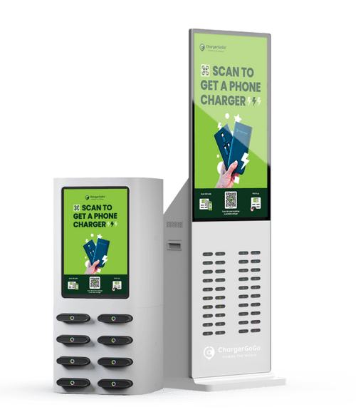 Two electronic kiosks for phone charging, one smaller station with six charging ports and one taller station with a large digital screen displaying a QR code and the text "Scan to get a phone charger."