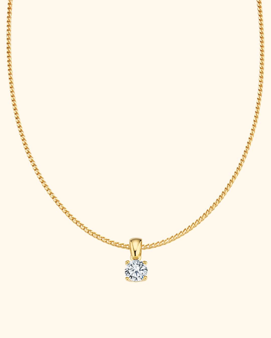 Goldene Halskette mit rundem Diamantenanhänger auf cremefarbenem Hintergrund.