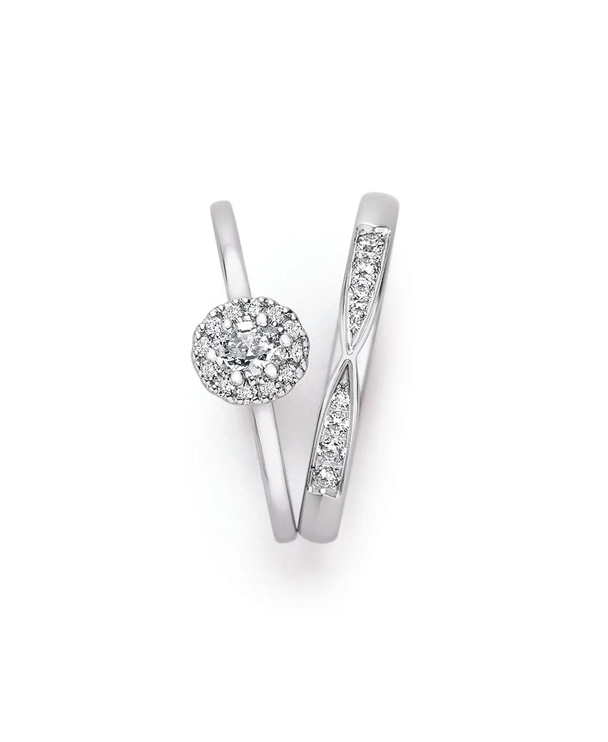 Zwei elegante silberne Ringe mit Diamanten, einer mit einem runden Diamanten in einer kreisförmigen Fassung, die andere mit einer geradlinigen Fassung, beide mit kleinen Diamanten verziert.