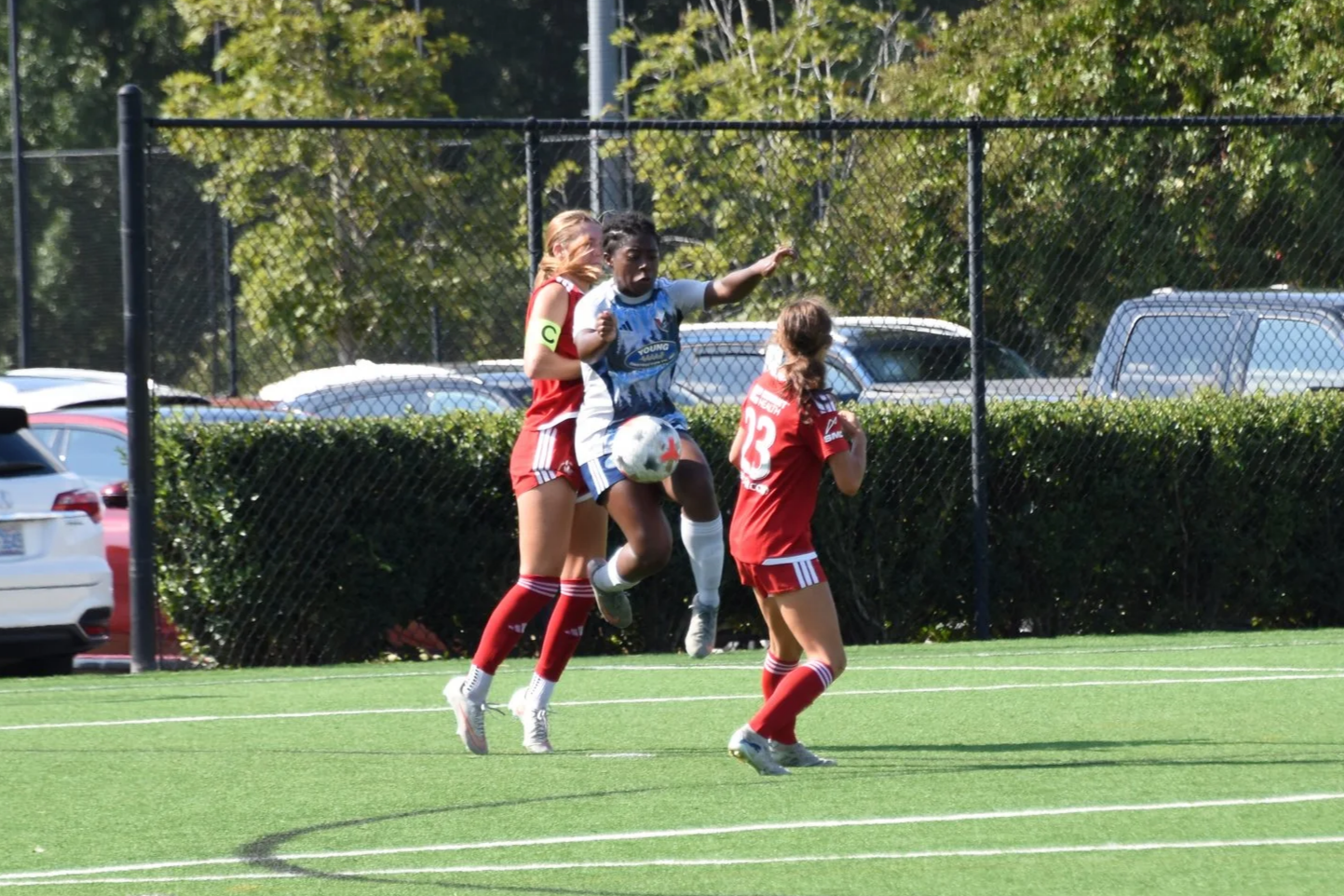 Michal Wilburn jumping to get the soccer ball