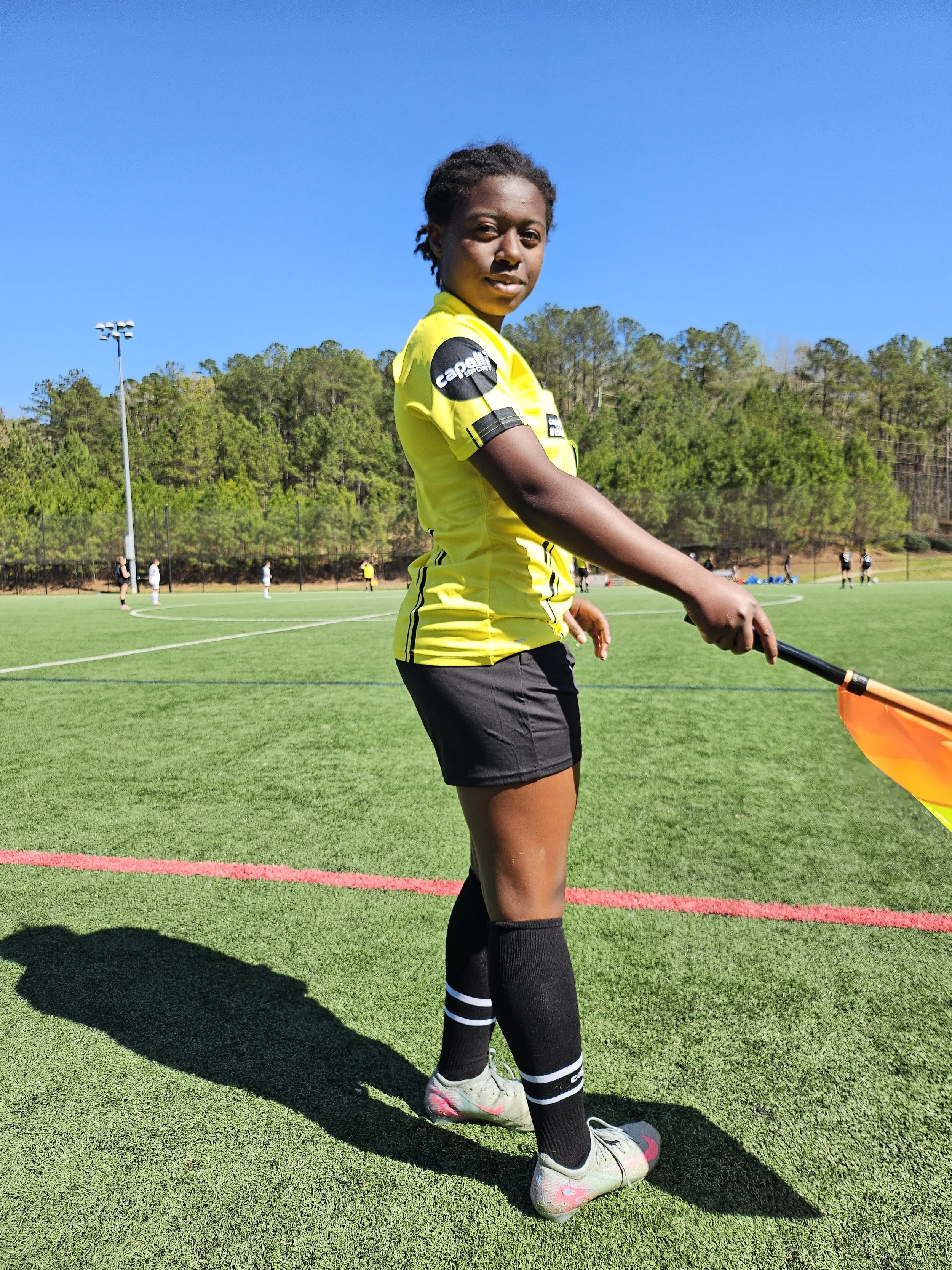 Michal Wilburn reffing a game; soccer forward, 2029
