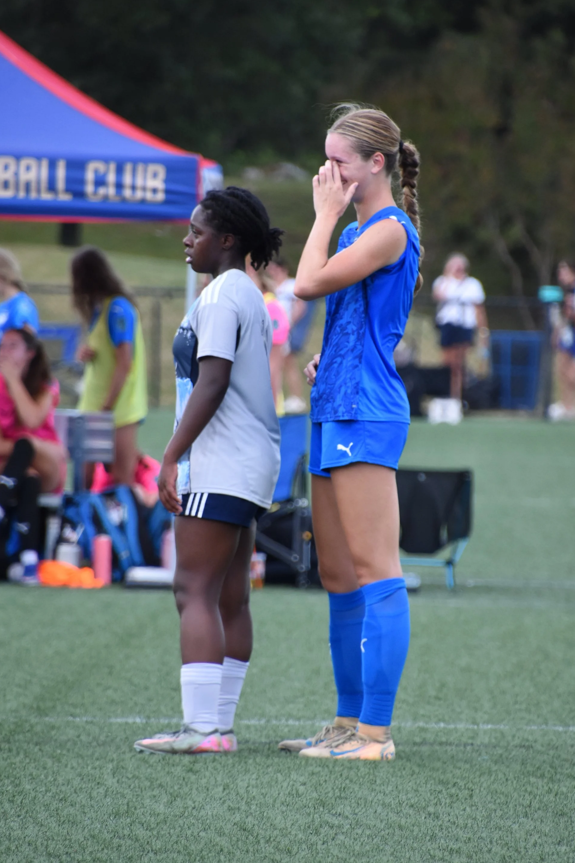Michal Wilburn stands near a tall defender
