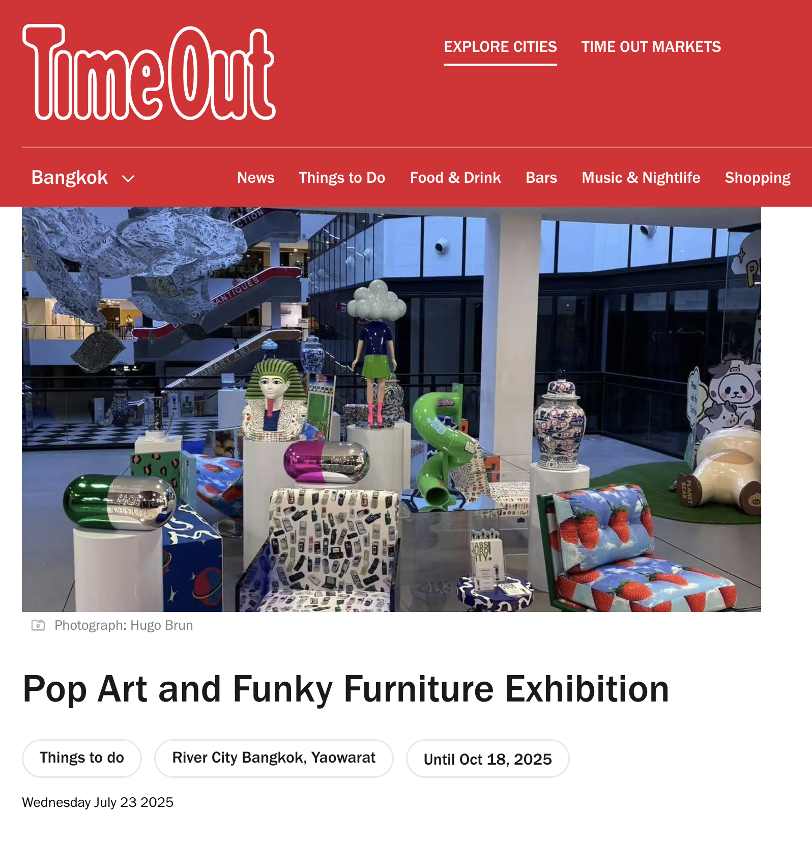A colorful art exhibit with playful furniture and sculptures in a shopping mall, promoting pop art and funky design.