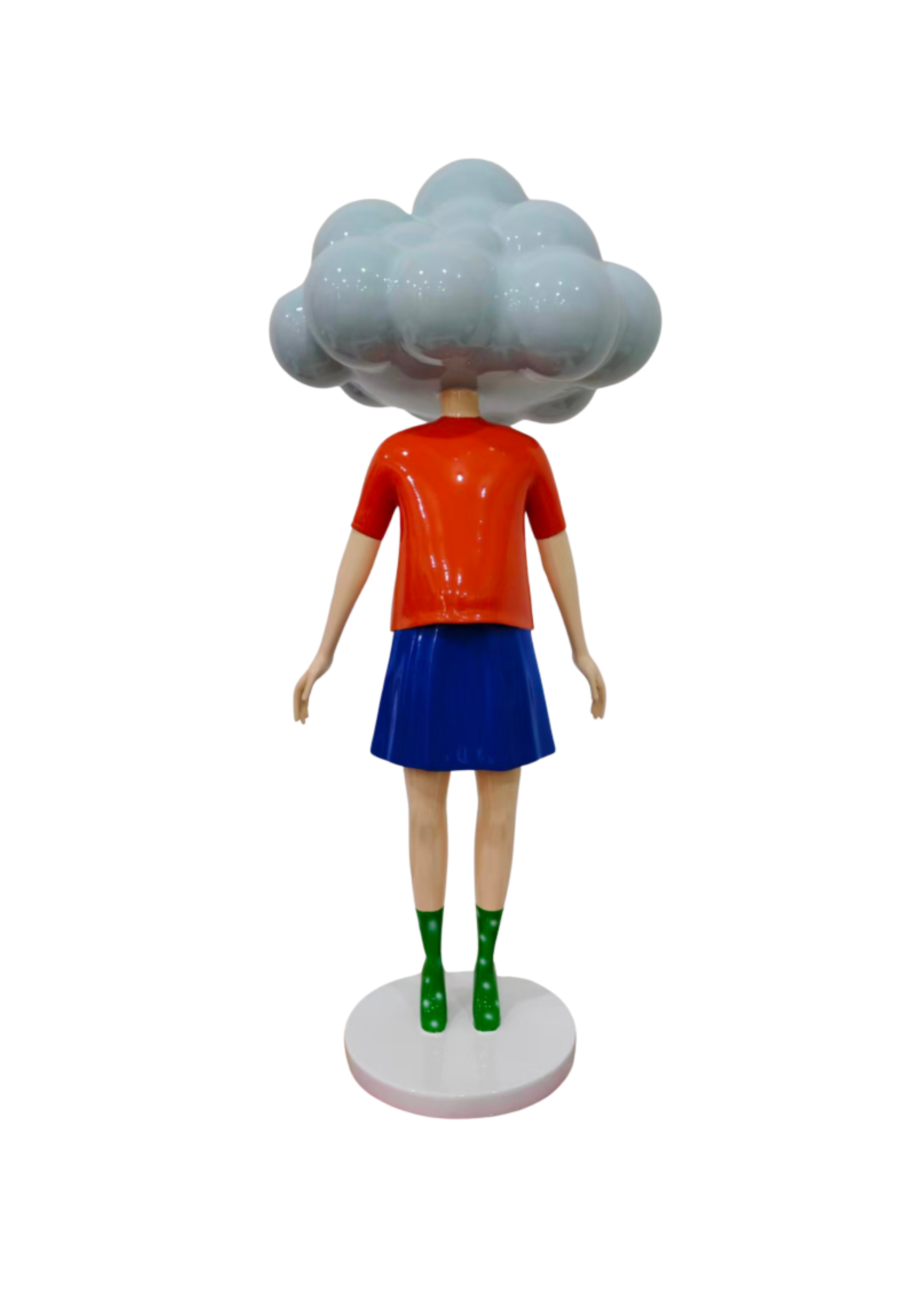A colorful toy figure with a cloud-shaped head, red shirt, blue skirt, and green glittery boots, standing on a white circular base.