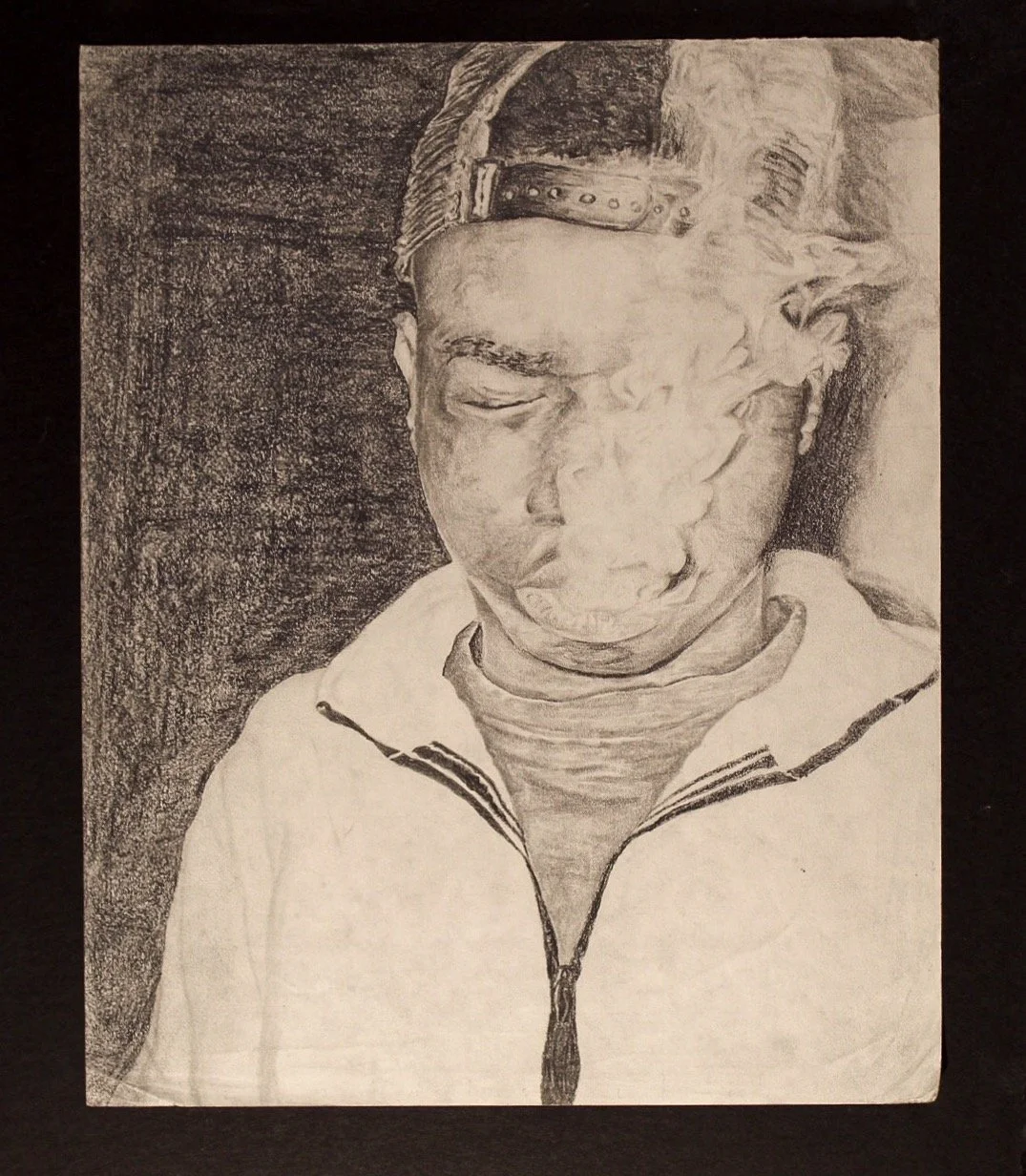 A pencil drawing of a young boy with closed eyes, wearing a cap and a zip-up hoodie.