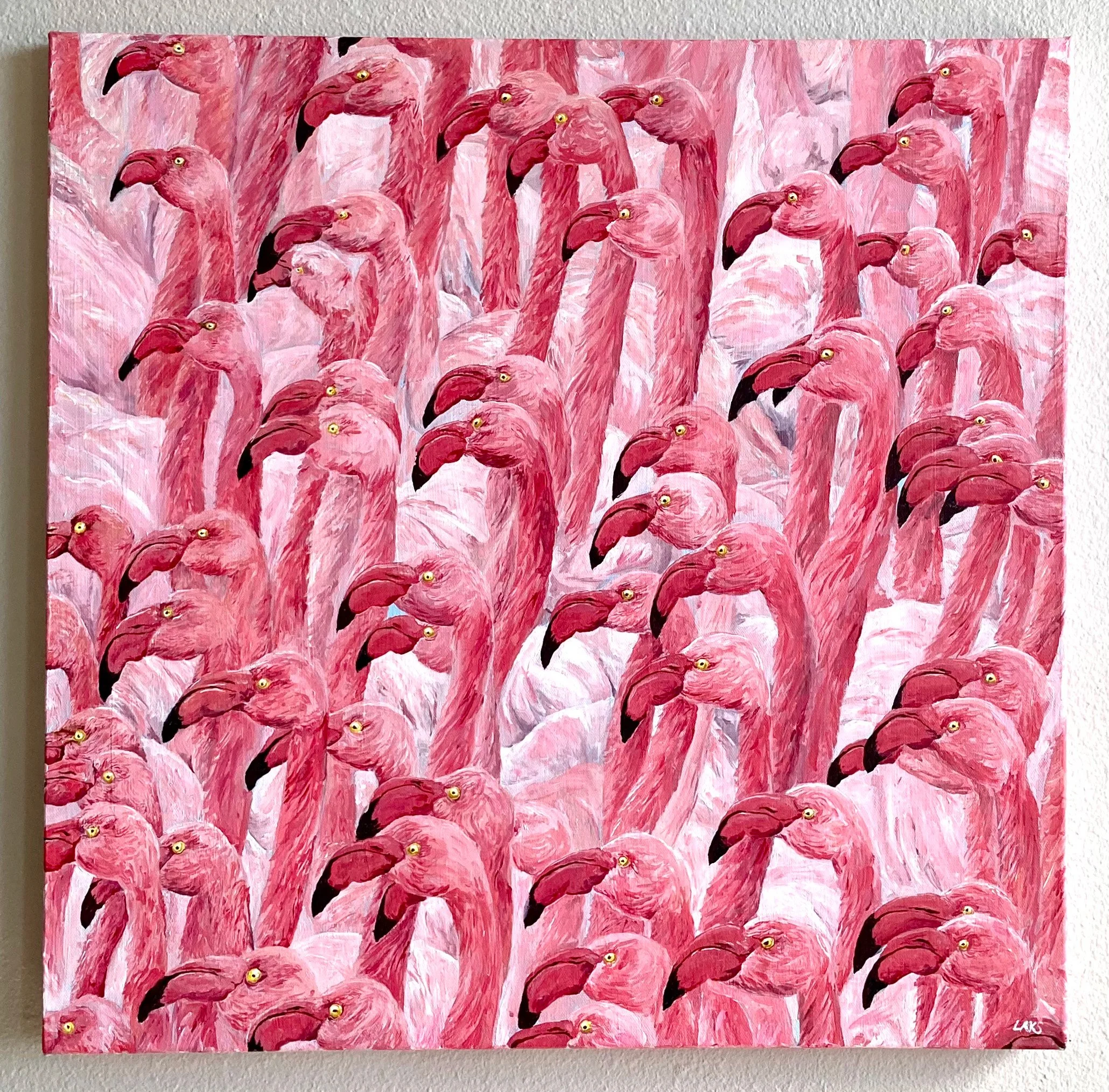 Painting of multiple pink flamingos with yellow eyes, black beaks, and detailed feathers, arranged closely together, hanging on a white wall.