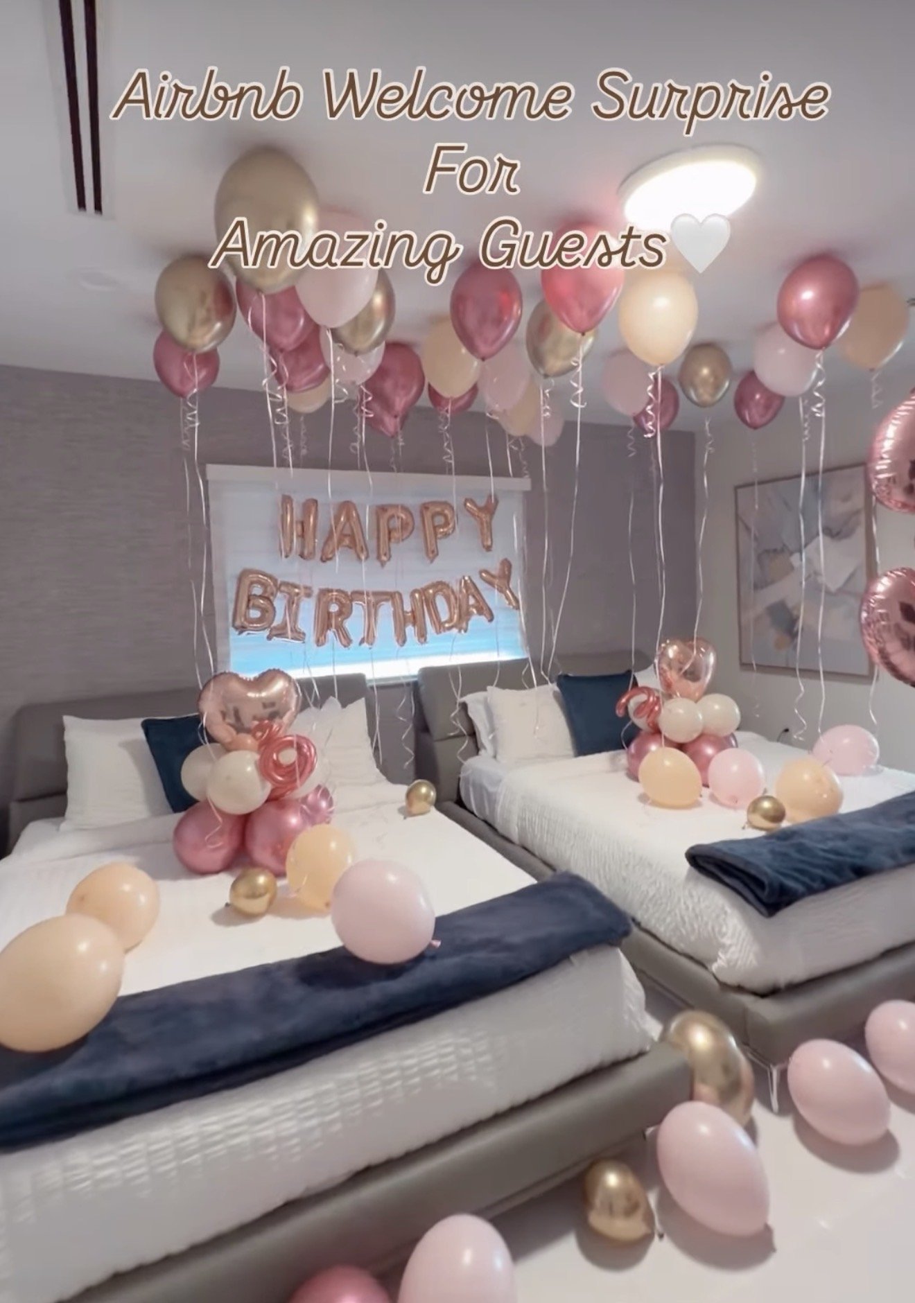 A bedroom decorated with pink, gold, and white balloons for a birthday celebration, with a