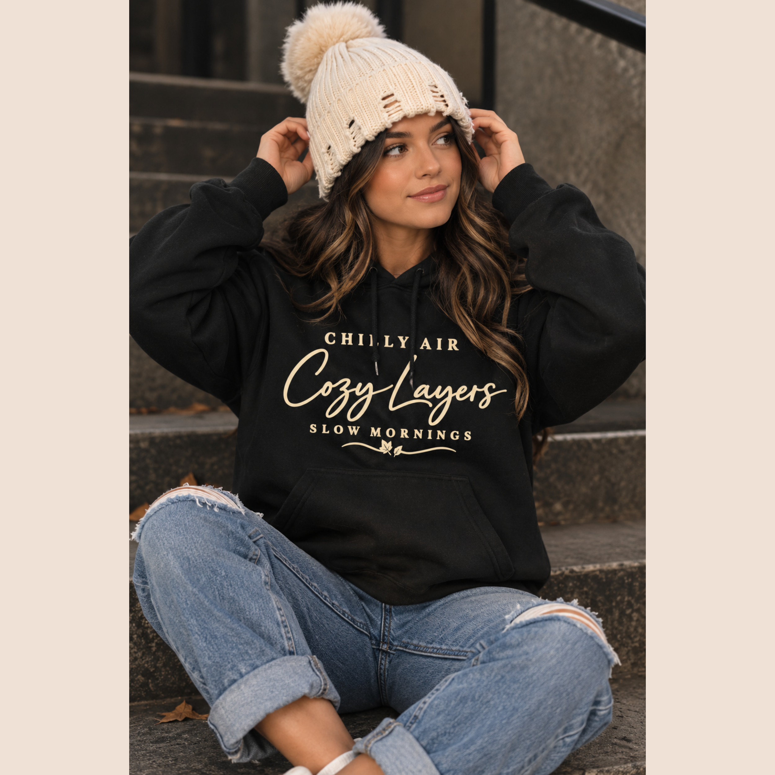 Women wearing the Chilly Air Cozy Layers black graphic hoodie with a knit beanie, styled for fall and winter.