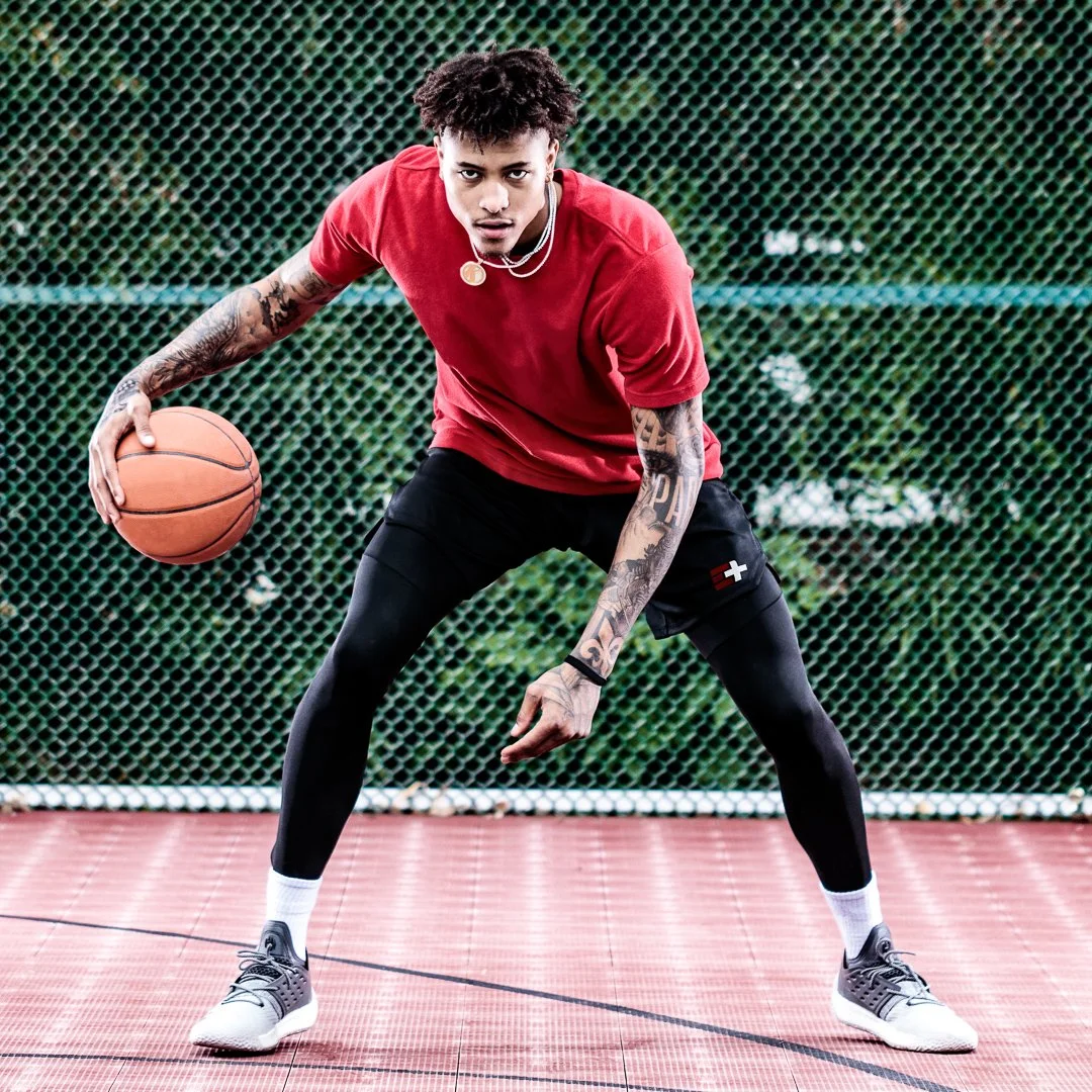 Basketball player on an outdoor court during a lifestyle photography shoot.