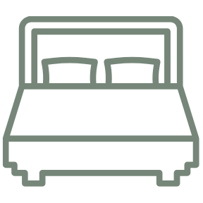 Simple line drawing of a bed with two pillows and a blanket.