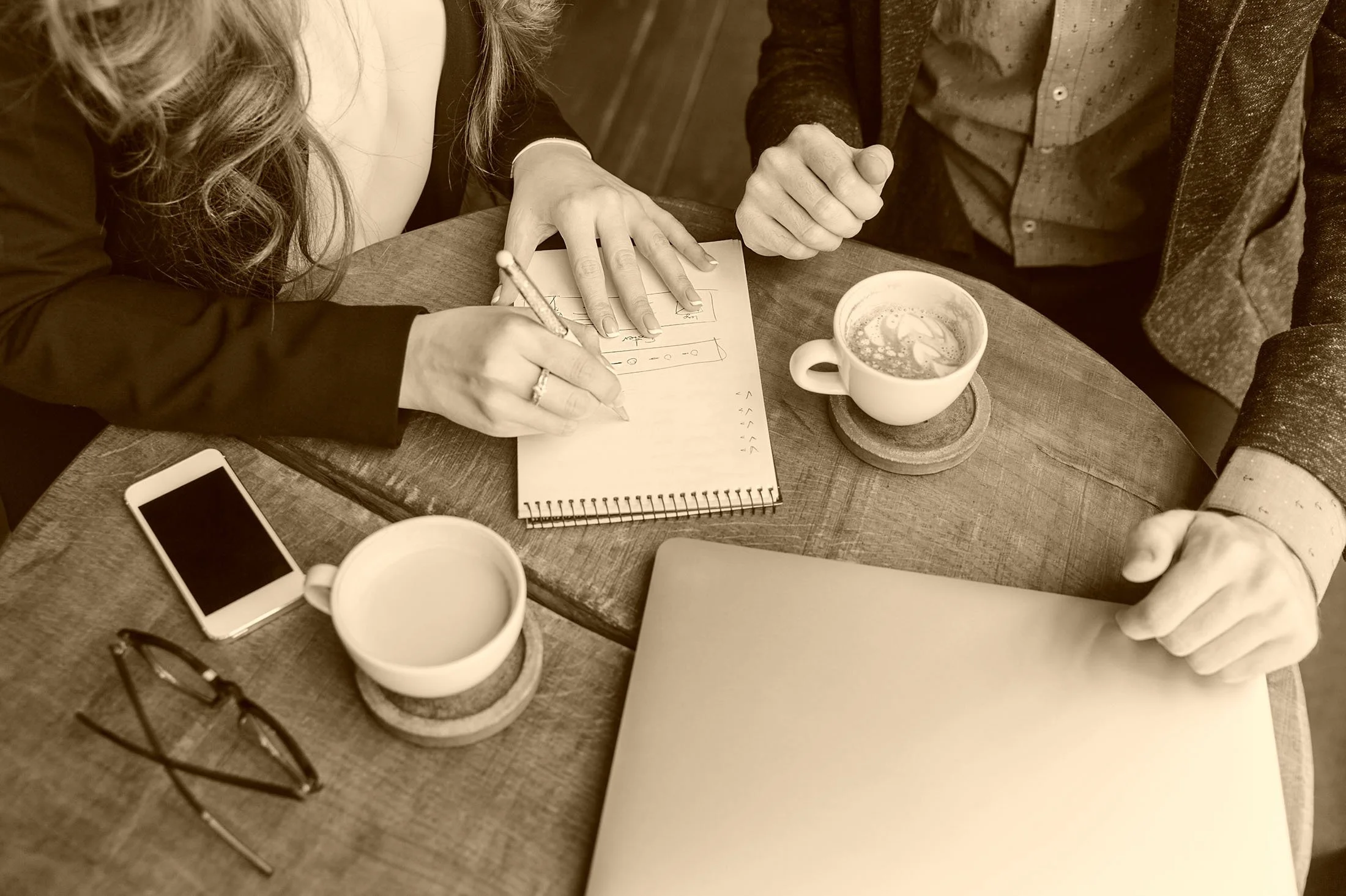 Leaders use a notebook to discuss ideas