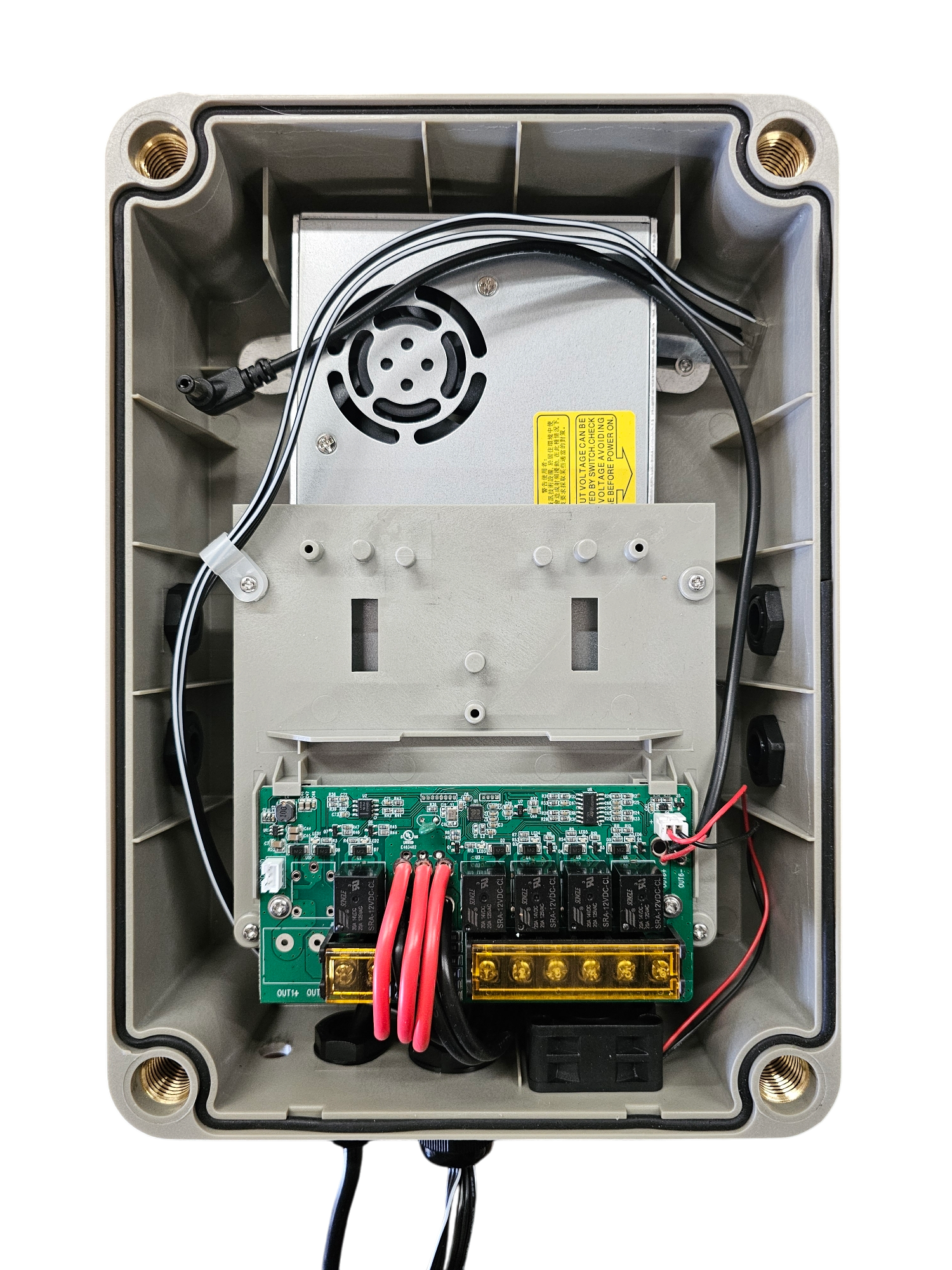 Interior of an electronic control or relay box with visible circuit board, wiring, and internal components.