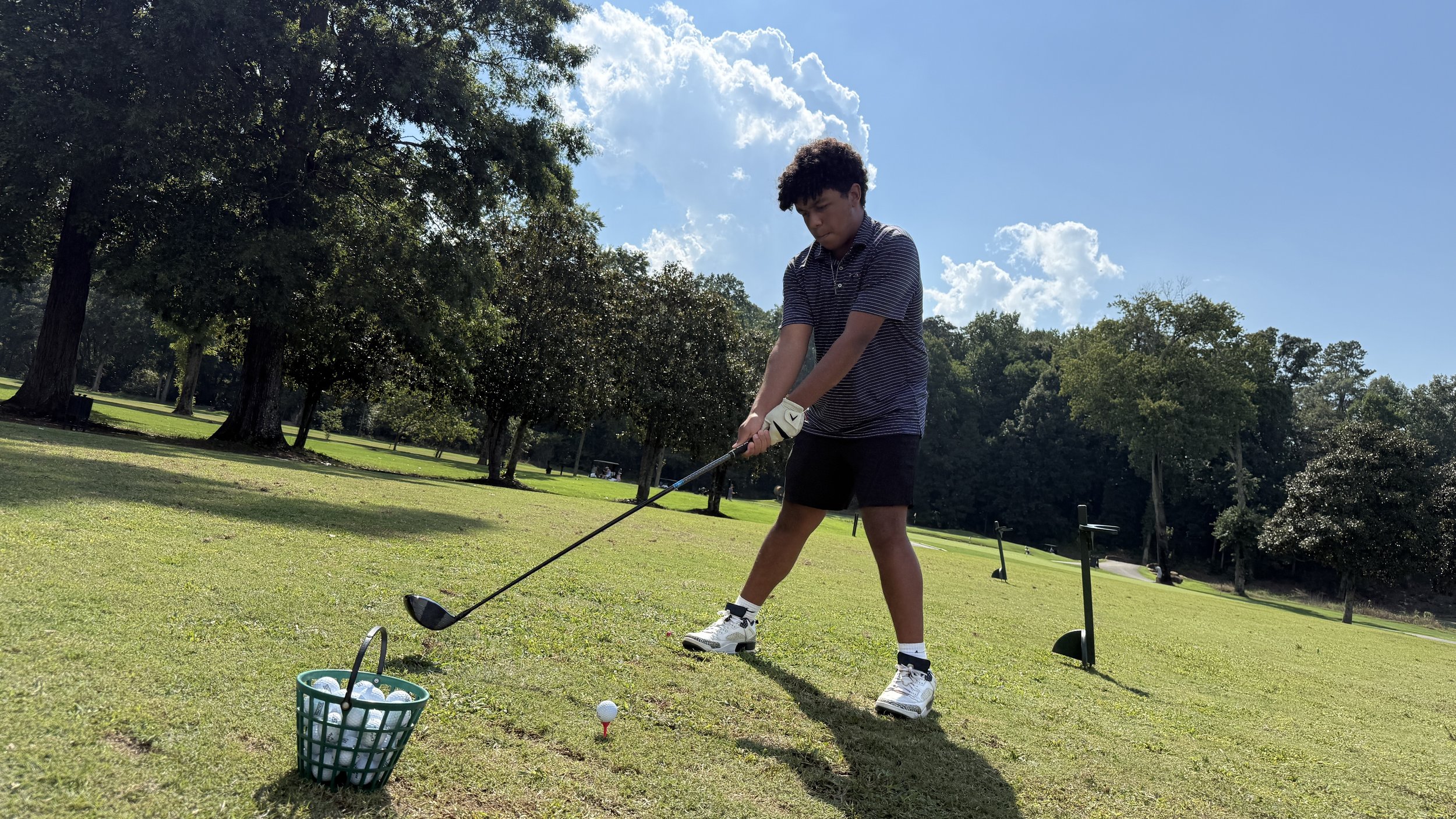 Gabriel Aldama practicing on the golf course.
