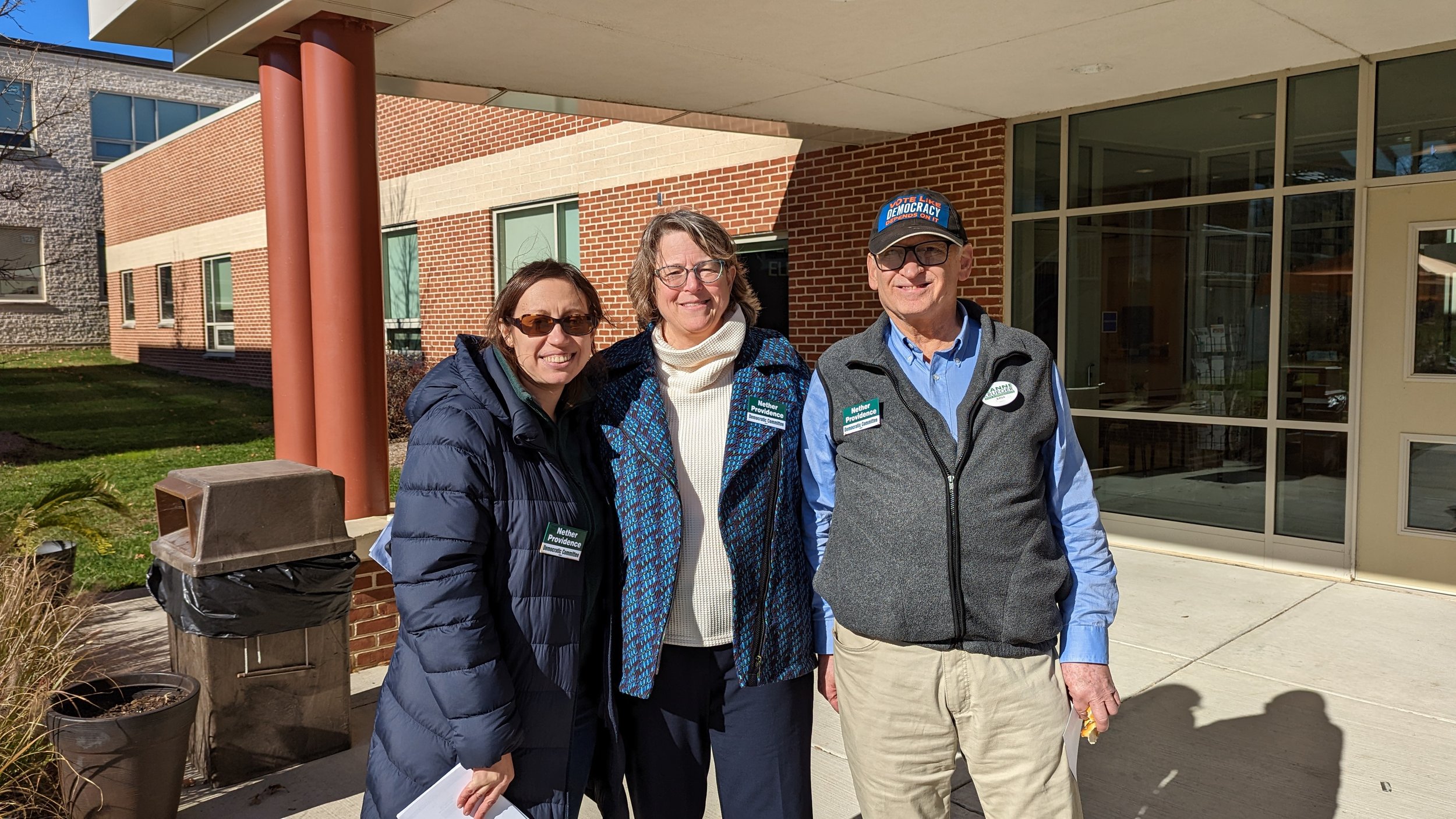 A group of people pose on Election Day after helping staff the polls