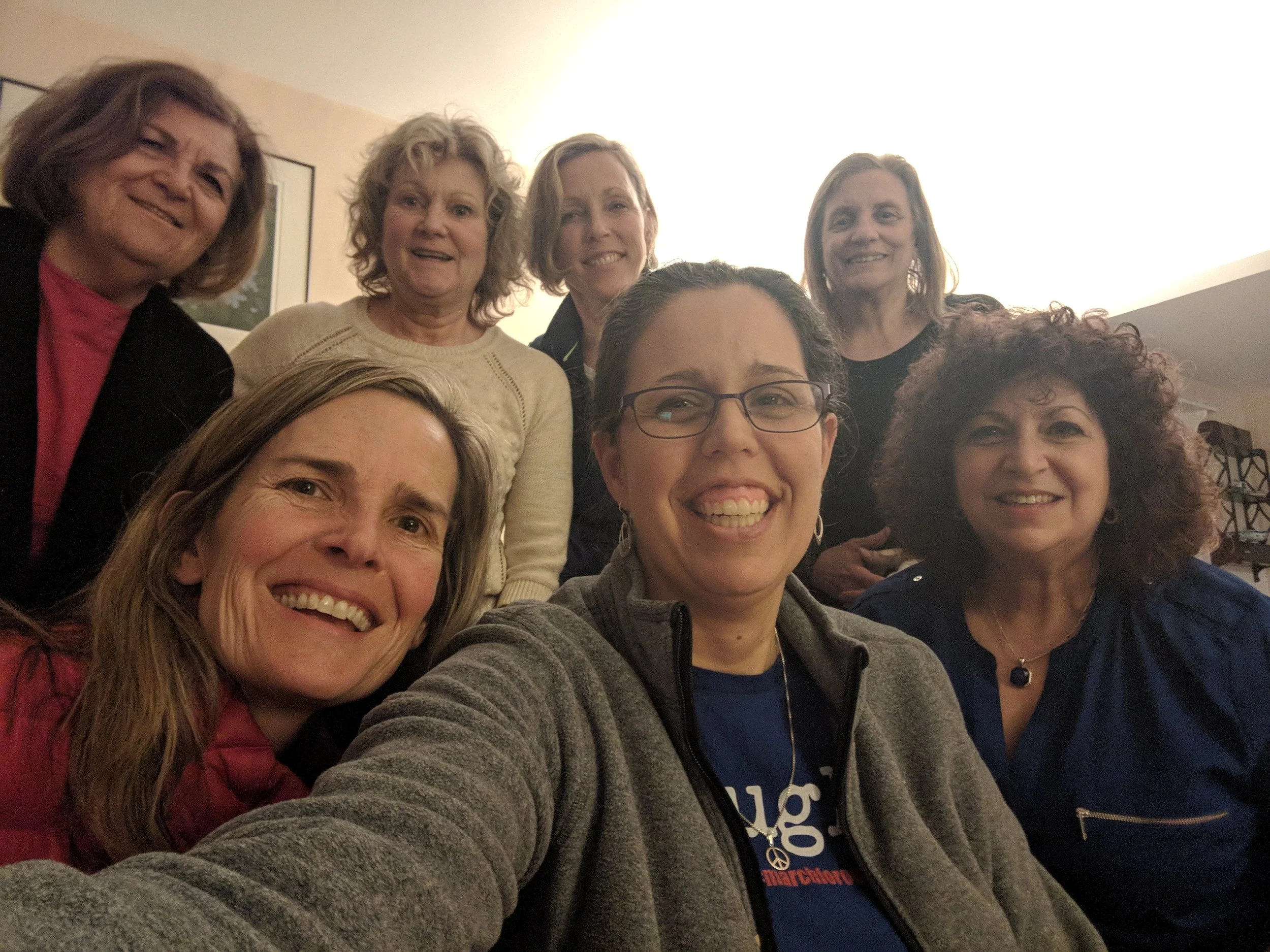 A group of people pose for a selfie at a political event