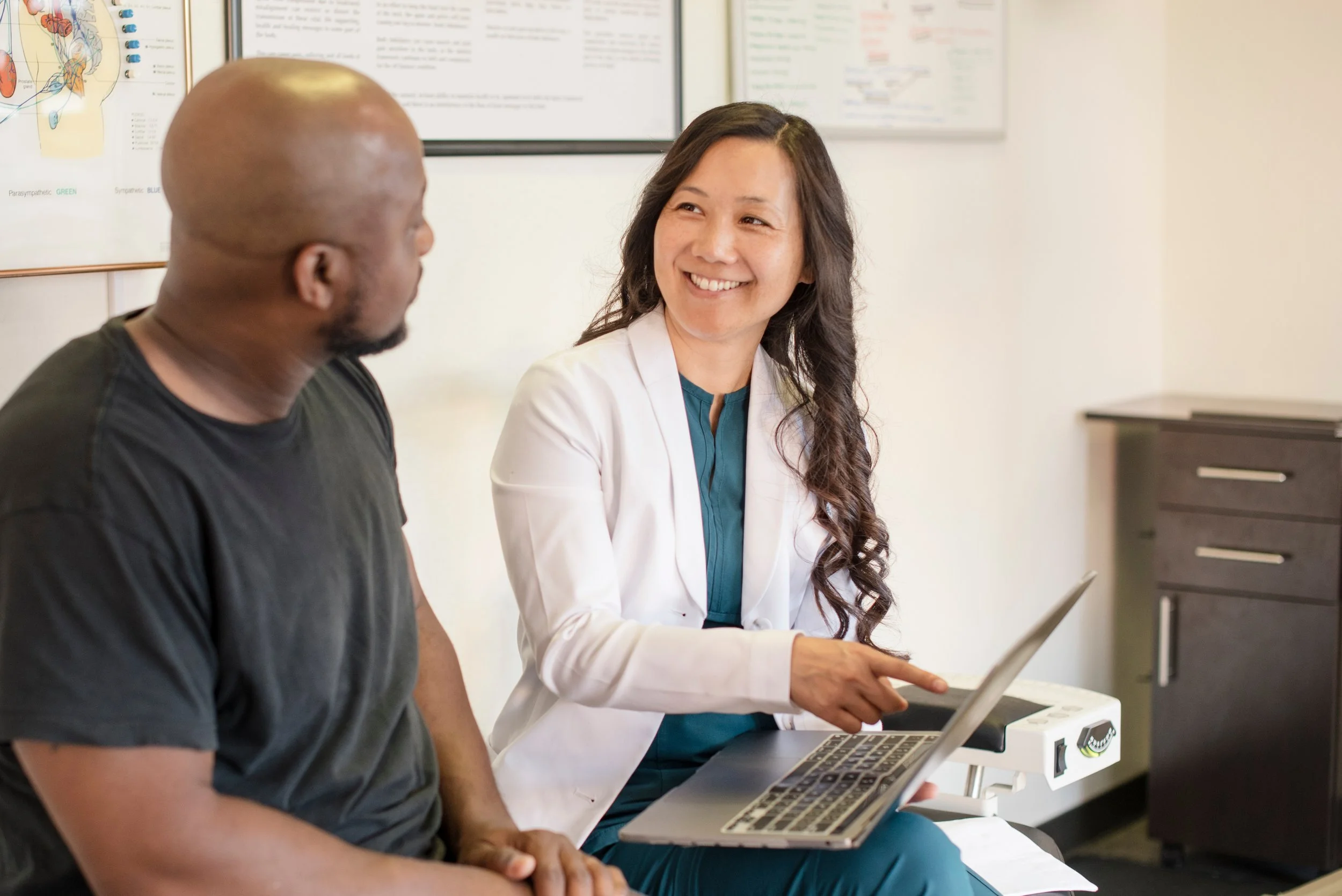 A male patient with a female doctor in a medical setting