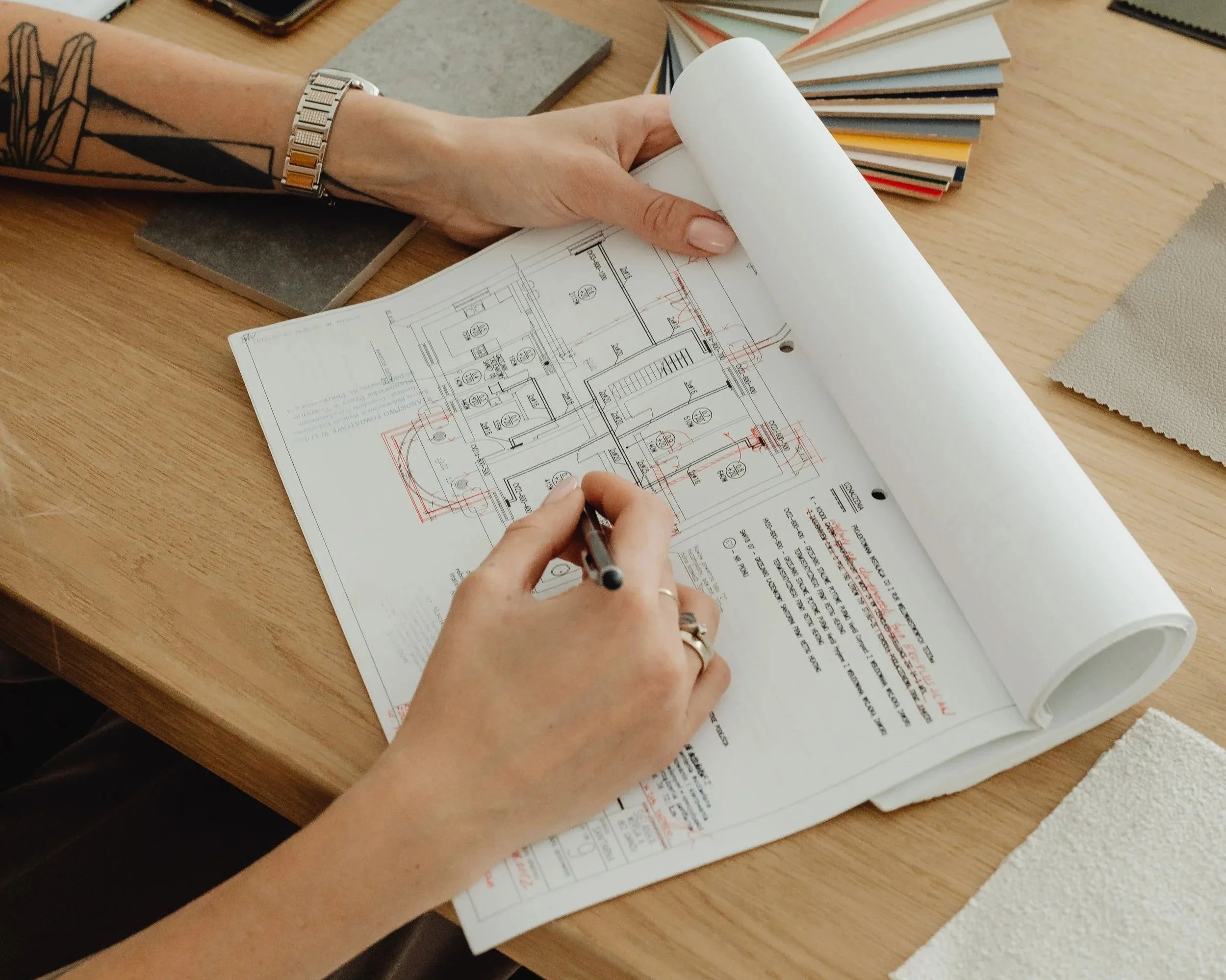 Interior designer reviewing architectural plans, color palettes, and fabric selections