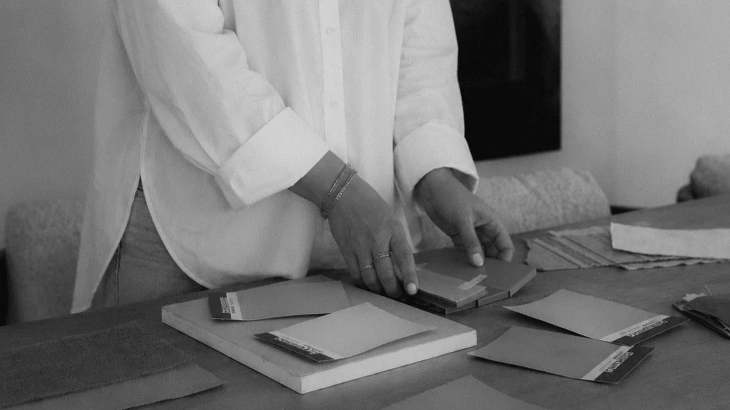 Designer arranging paint and material samples for an interior design project