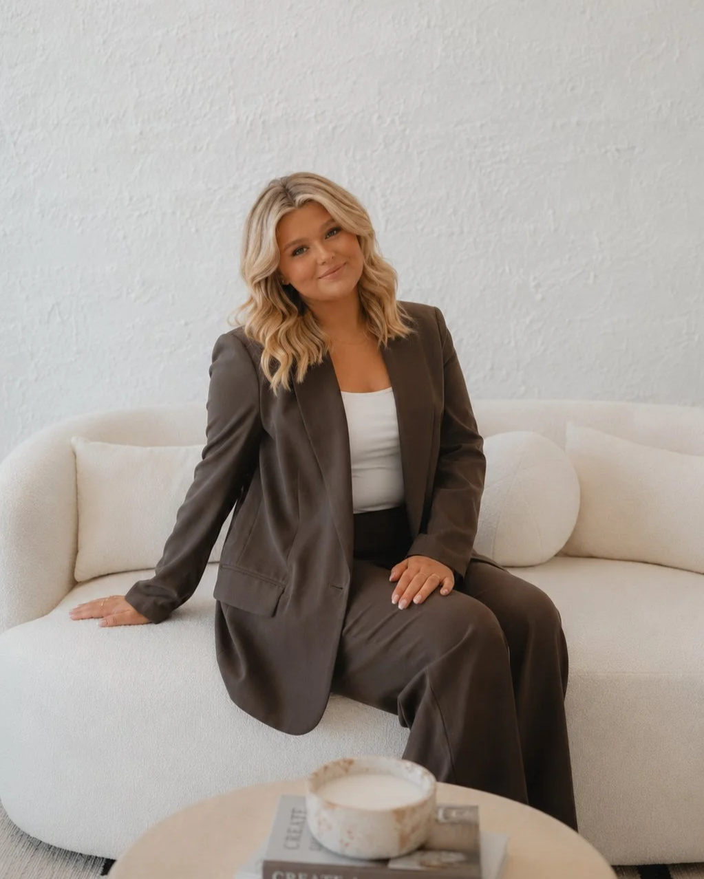 Hannah Sweet of Sunday House Design Co. in a warm, neutral interior