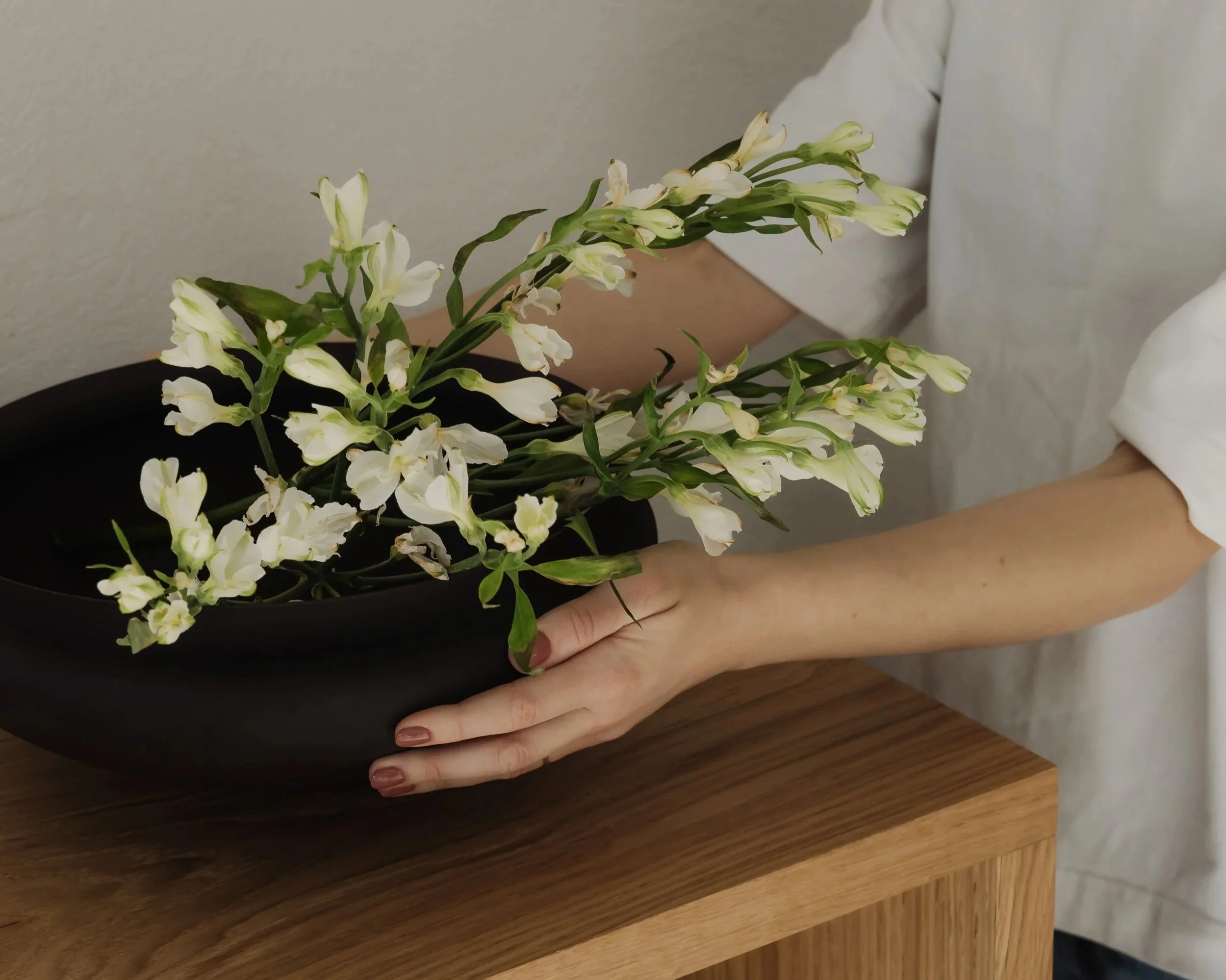 Styling floral arrangement and accessories for an interior design installation