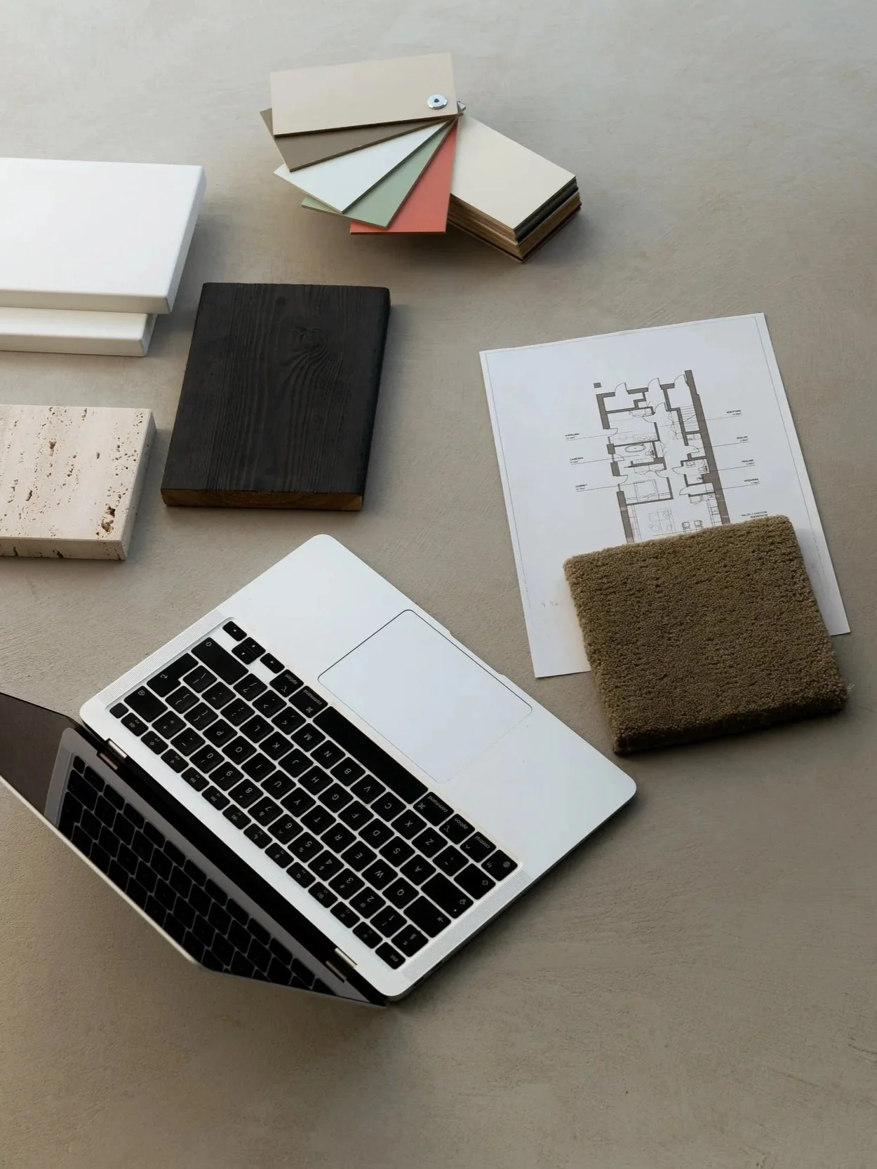 Interior design workspace with floor plans, material samples, and finish selections
