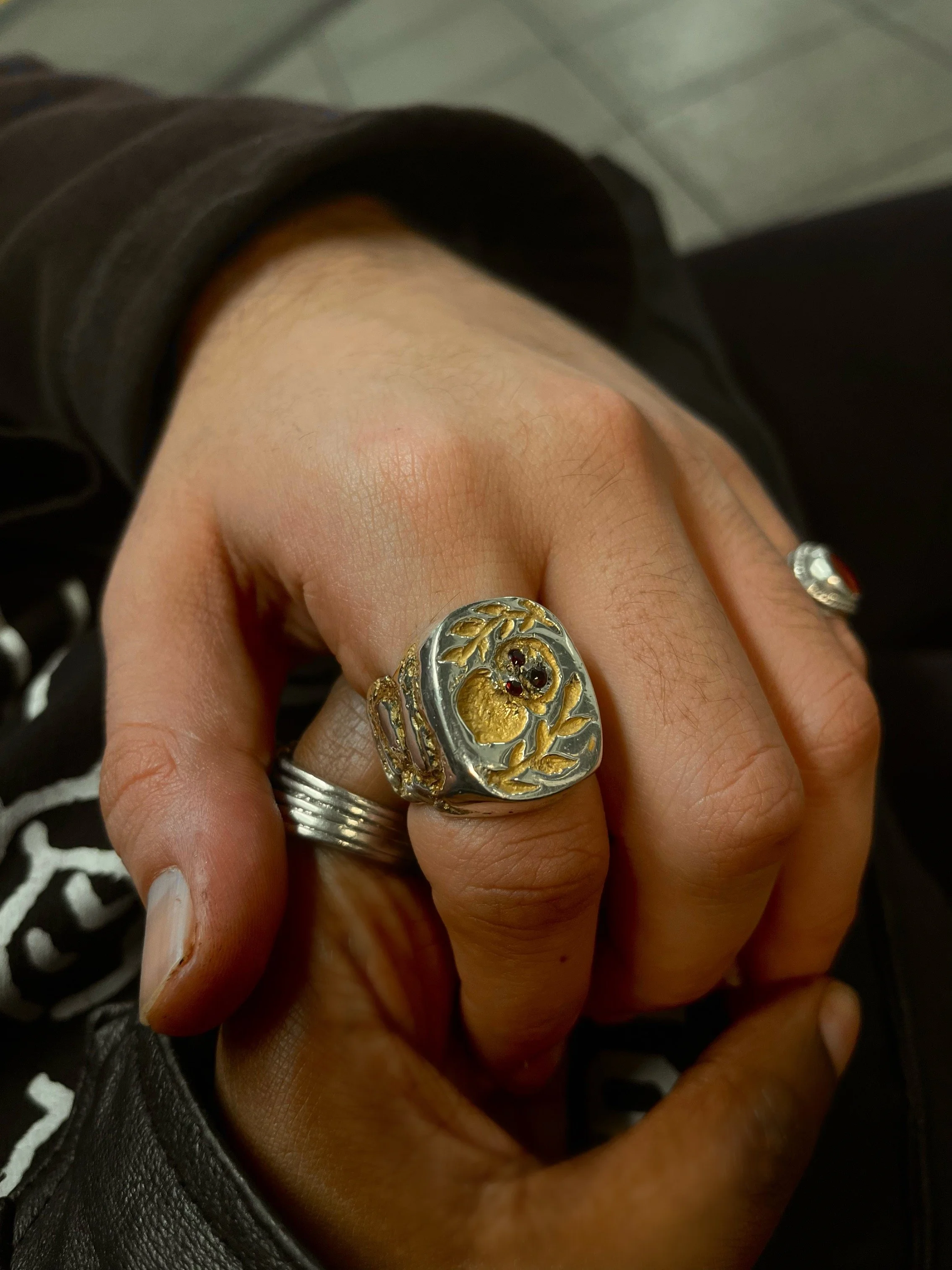 A Bespoke hand carved sterling silver signet ring with 24k gold inlaid and rubies set