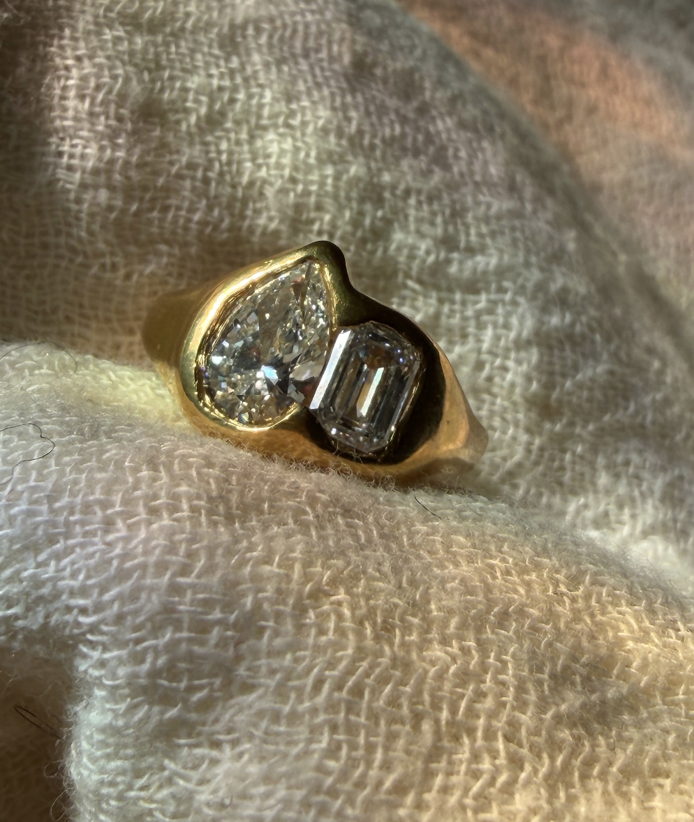 18k yellow gold toi et moi ring with pear-cut and emerald-cut lab-grown diamonds in organic bezel settings