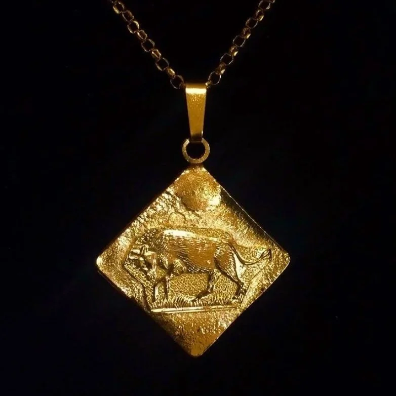 A custom 18k Gold Taurus medallion pendant