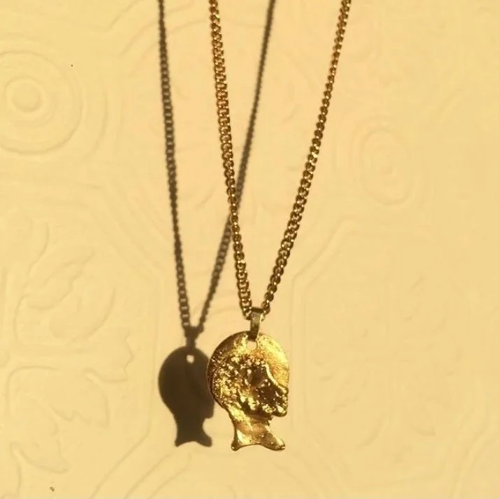 A 9k yellow gold custom Saint pendant