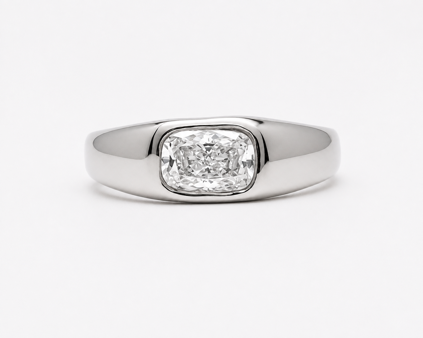Polished 18k 9k white gold ring with elongated cushion-cut white diamond in an organic bezel setting