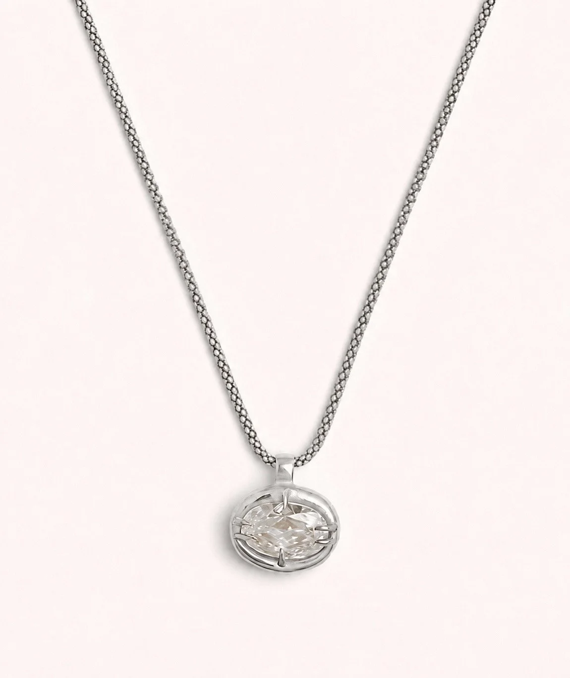 18k 9k white gold necklace with oval-cut white diamond pendant in an organic claw setting.