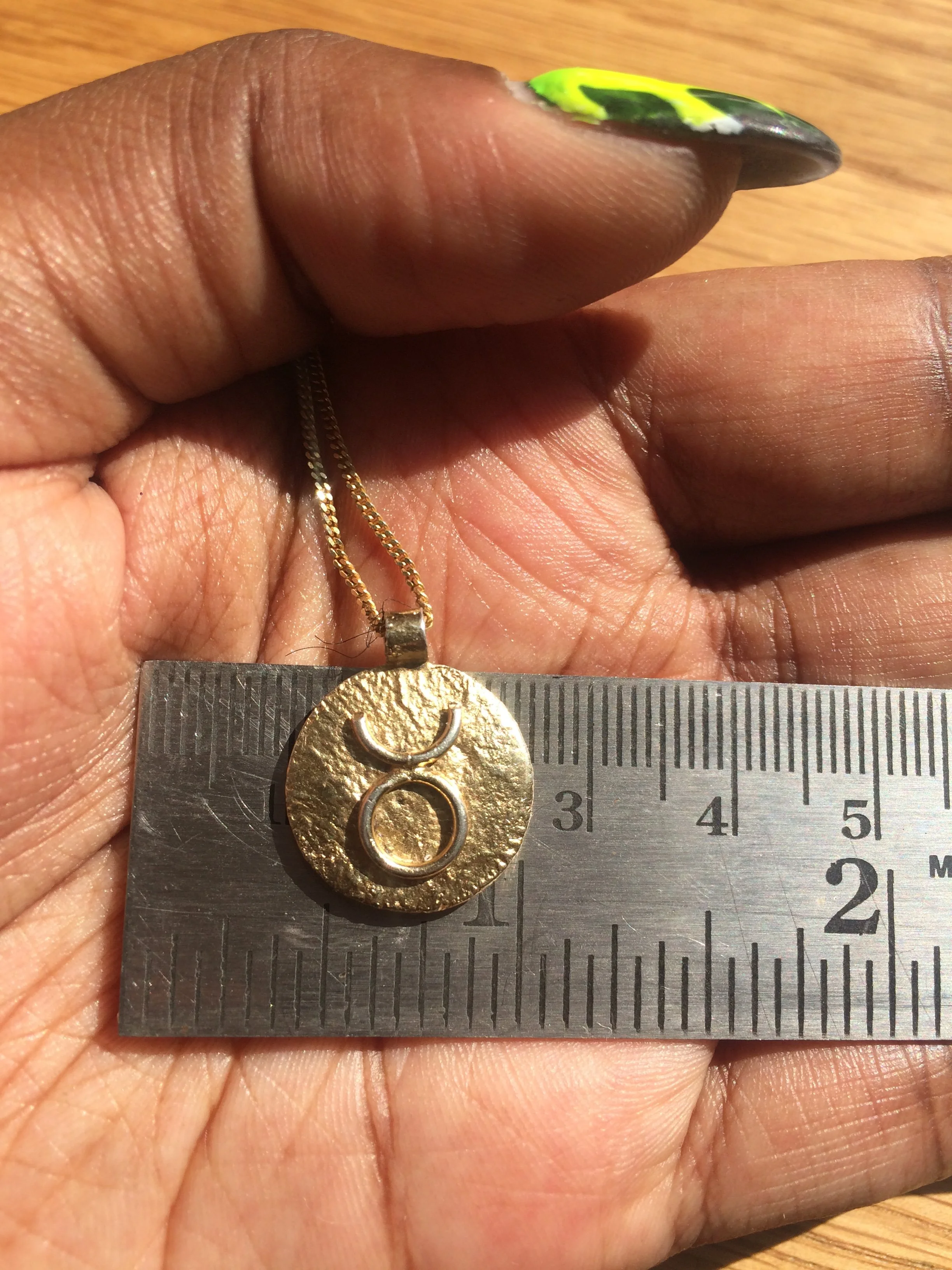 A bespoke 18k Gold Taurus Pendant
