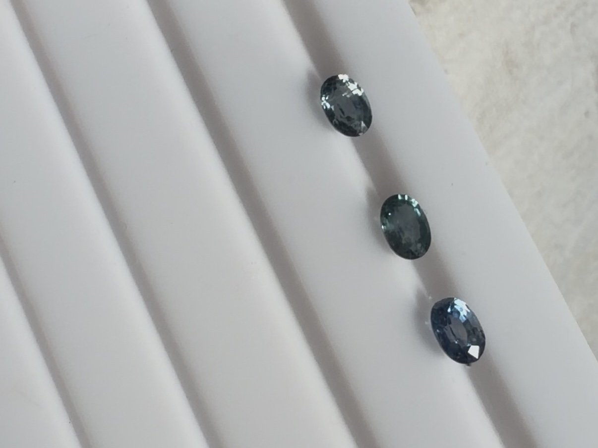 Three blue and teal colour oval sapphire gemstones