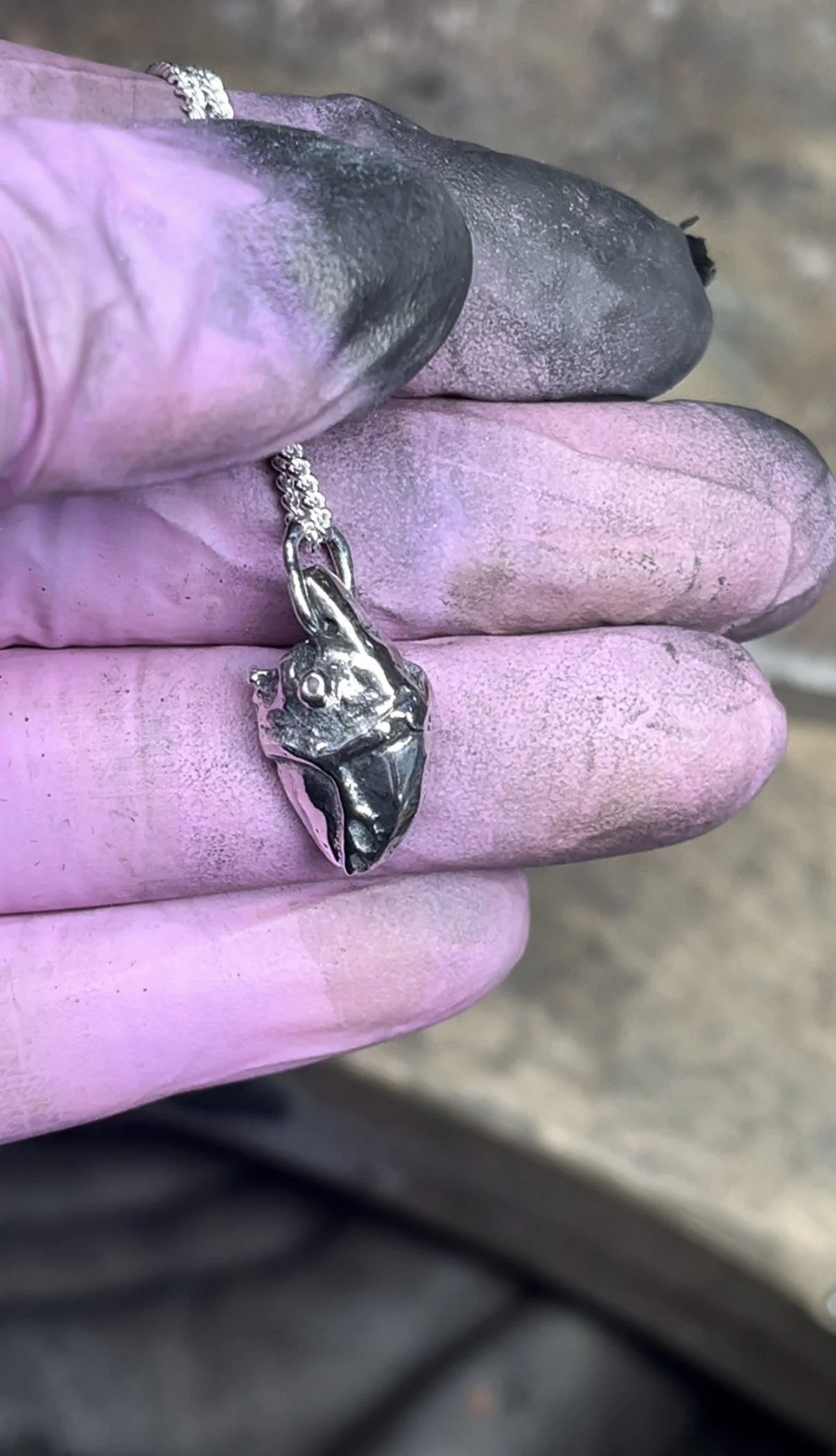 A hand carved sterling silver heart pendant