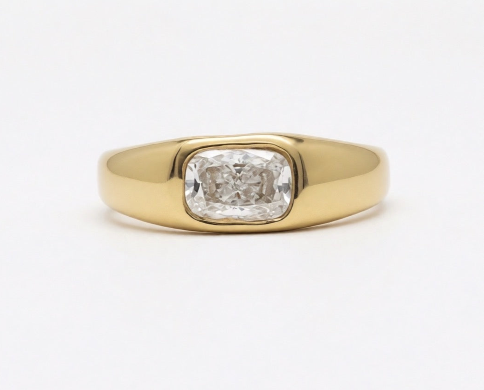 Polished 18k 9k yellow gold ring with elongated cushion-cut white diamond in an organic bezel setting