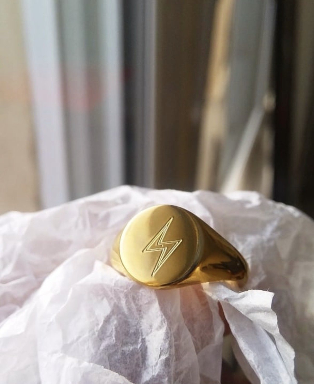 18K signet ring with a lightning -bolt engraved on the front