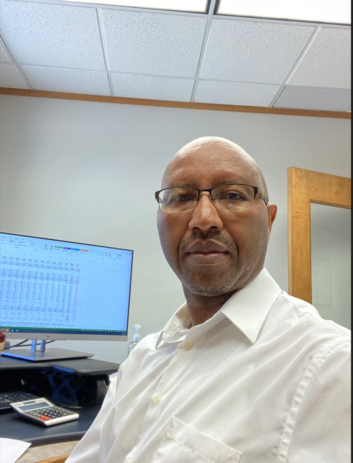 Christopher Tegwe at his desk at XpressBooks ND