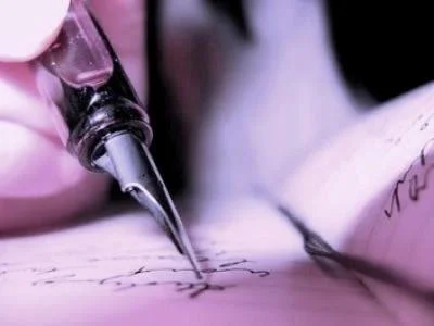 Close-up of a fountain pen writing on paper.