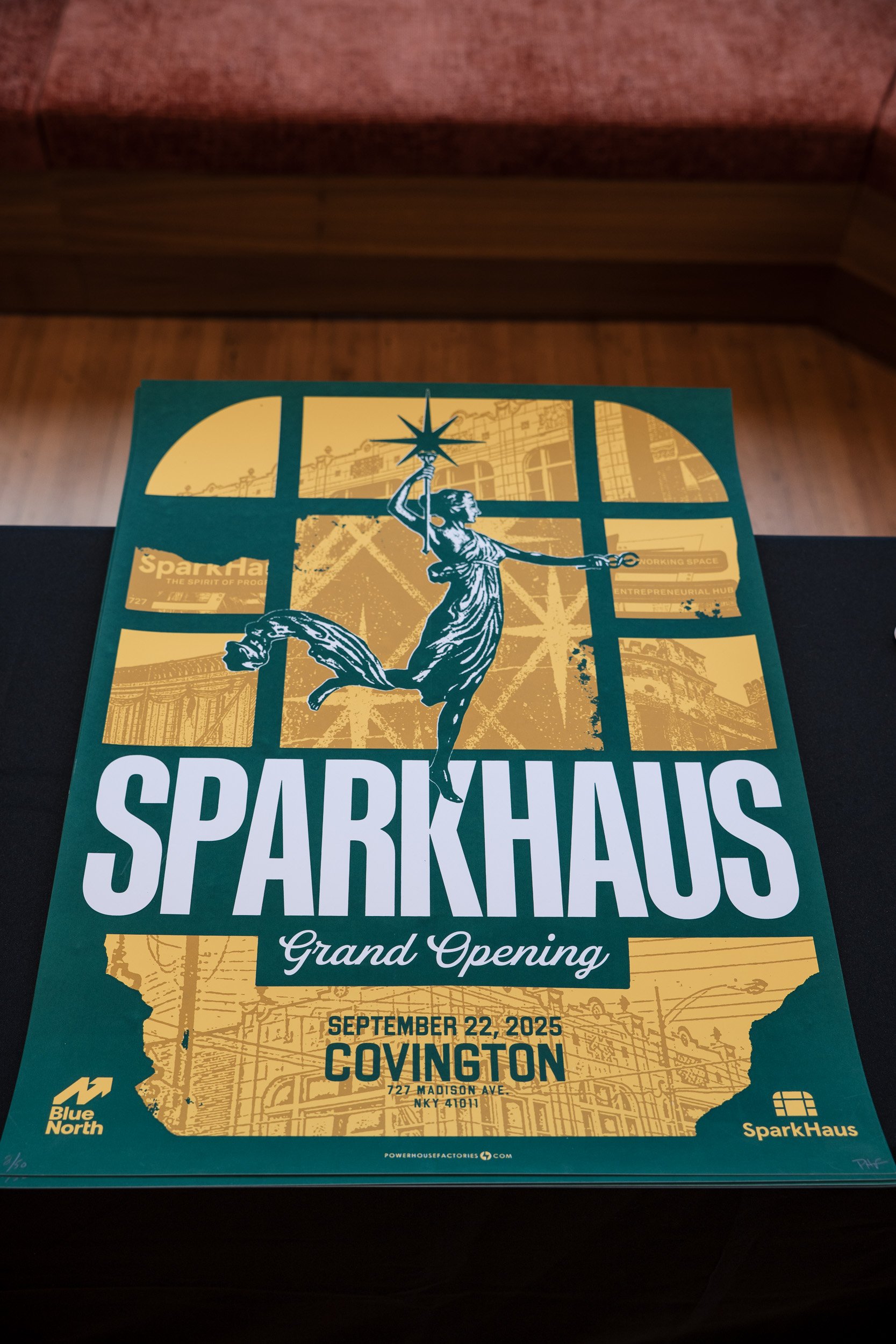 Flyer for Sparkhaus grand opening on September 22, 2025, in Covington, New York, featuring an illustration of a woman holding a star, with a cityscape background and event details at the bottom.