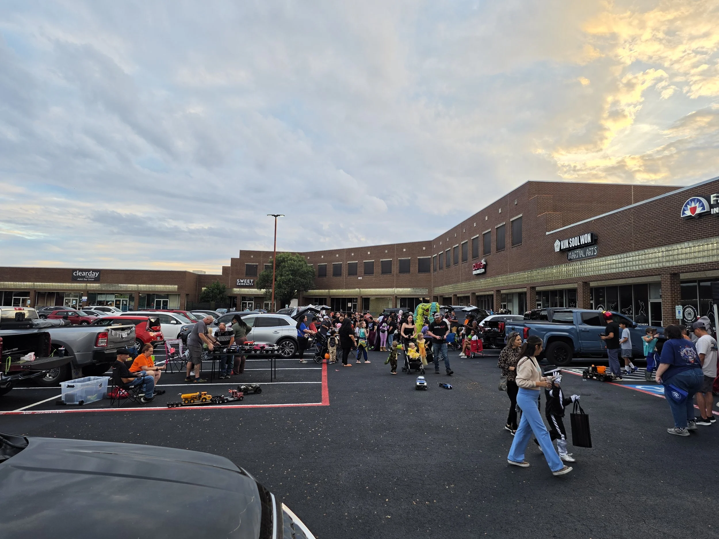 Pakring lot with people Trick or Treating at the Alamo City Hobby Shop annual Trunk or Treat.  Scale RC 18 wheeler in the parking lot.